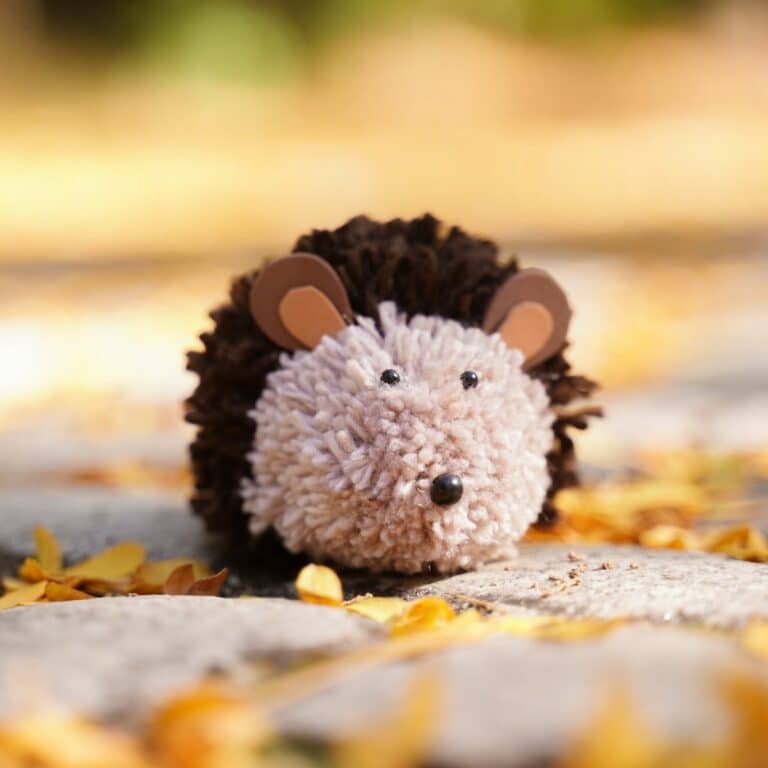 Toy hedgehog sitting on rock