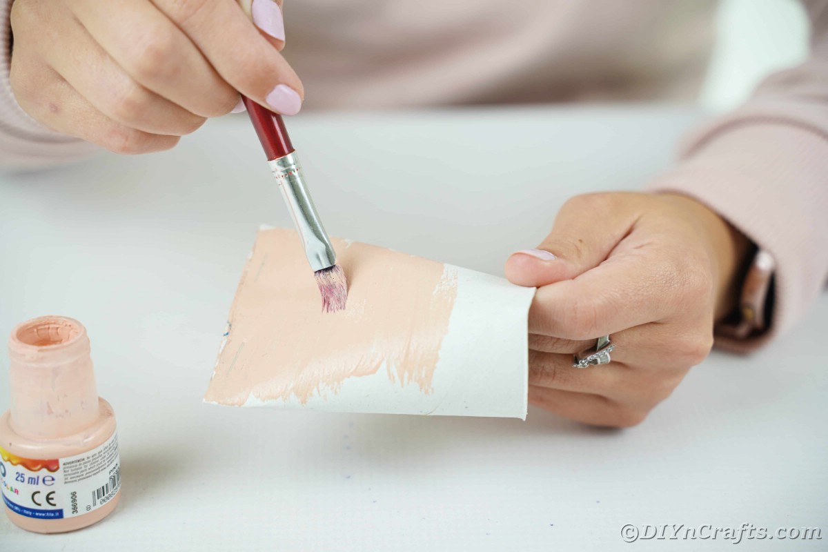 Hand painting toilet paper roll tan
