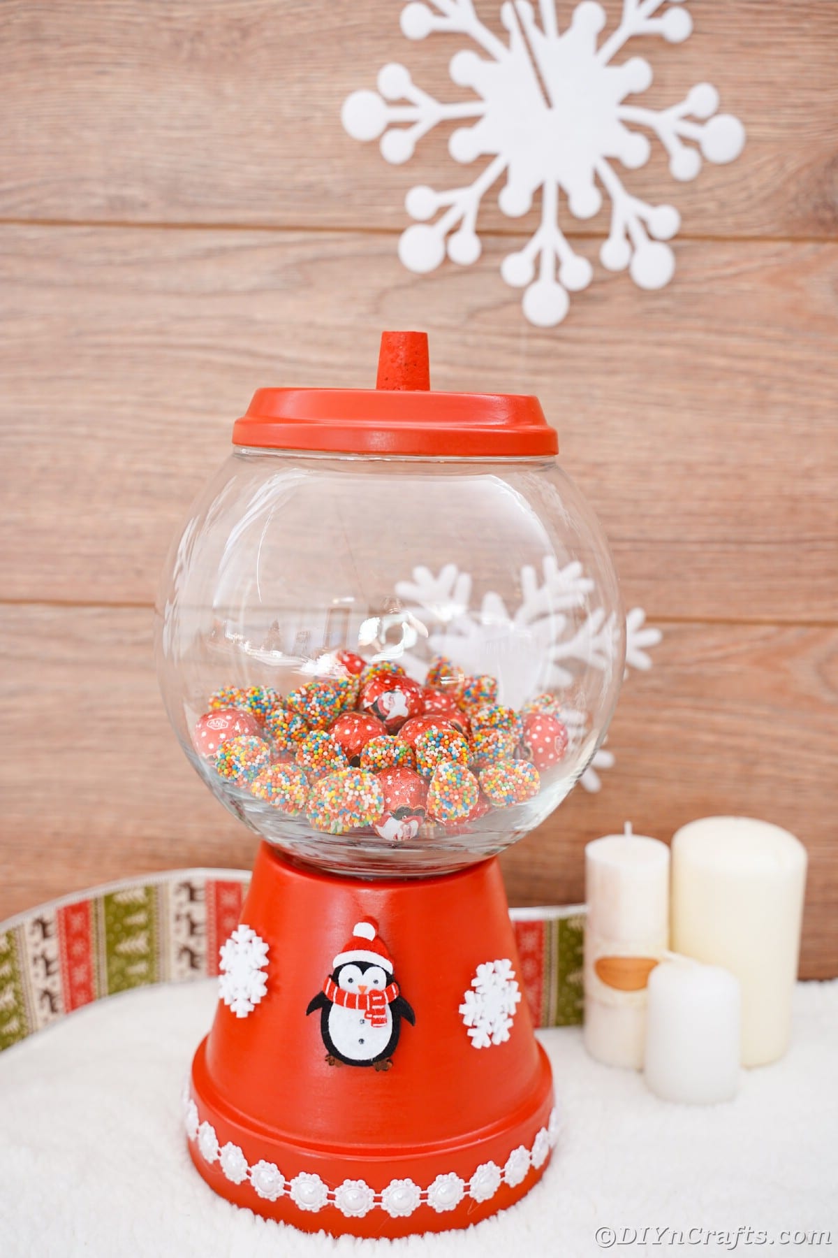 flower pot candy jar with glass top against wood wall