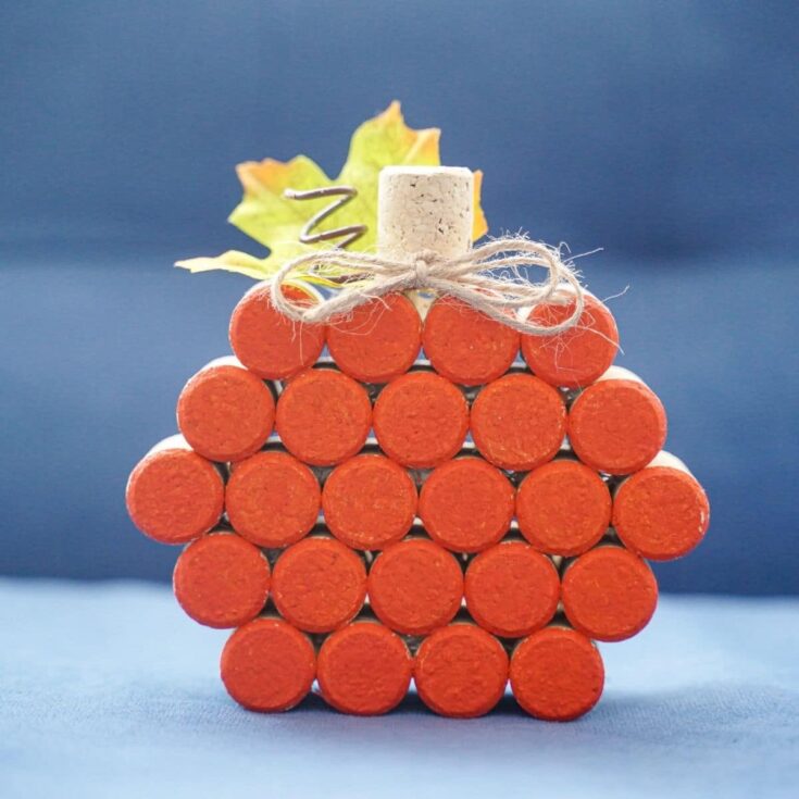 cork pumpkin in front of blue sofa