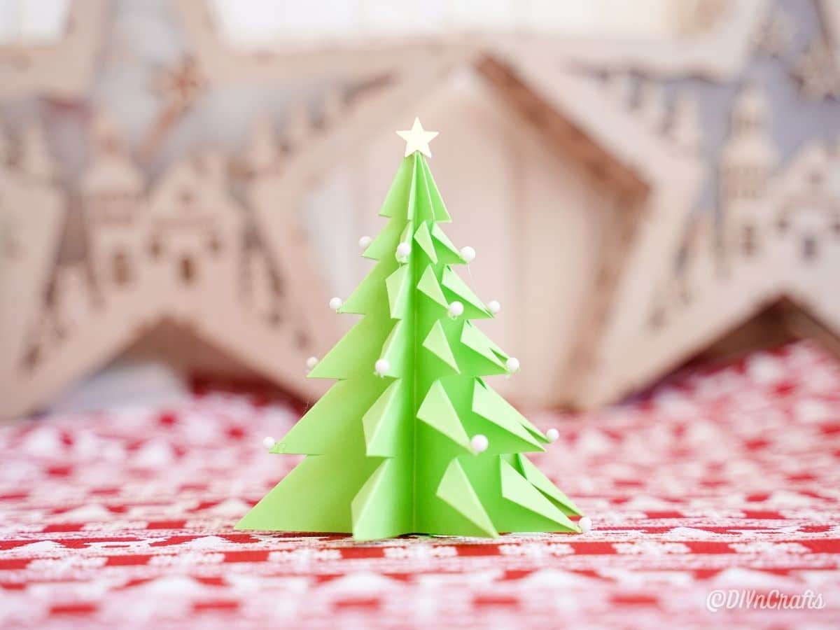3D paper tree on red and white holiday paper