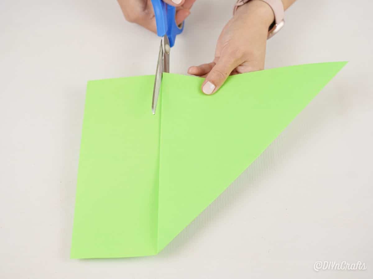 hand cutting green paper