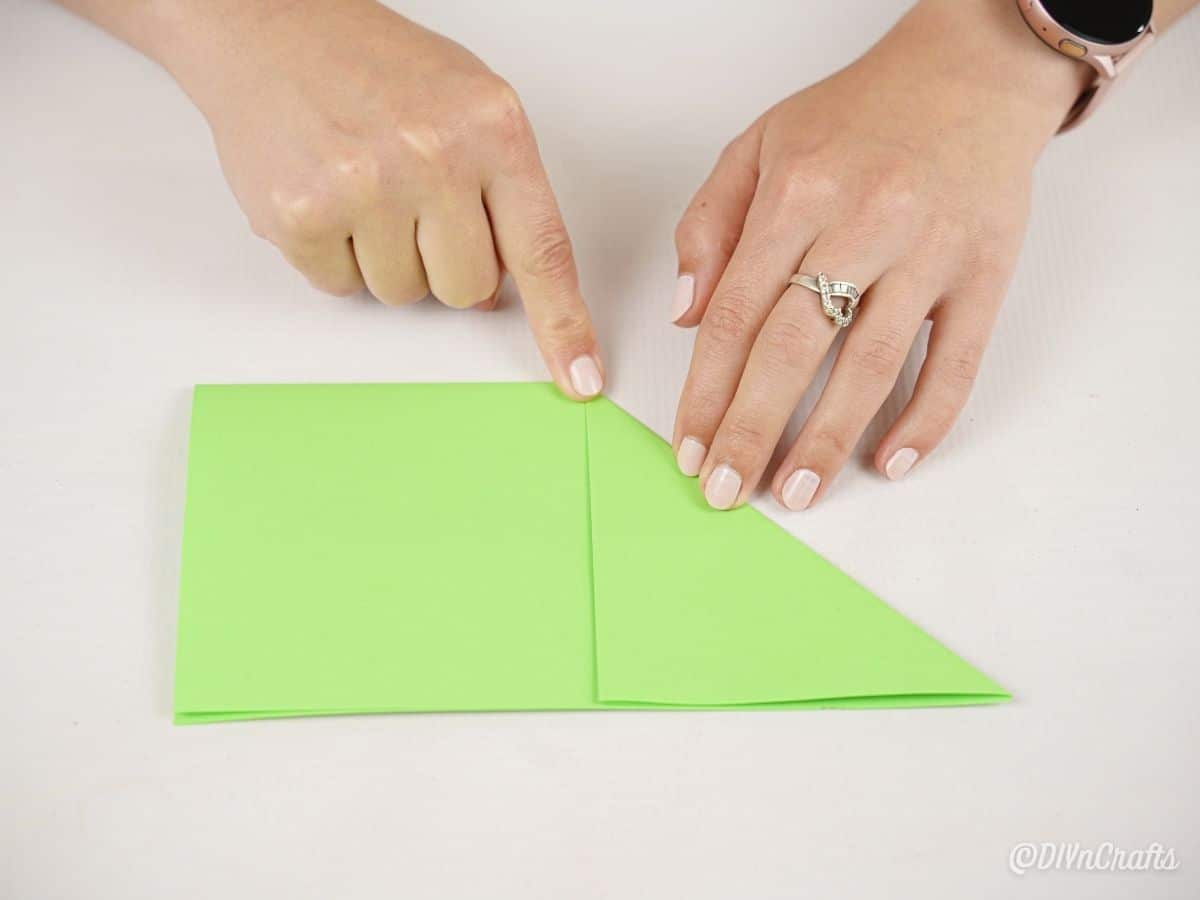 hands creating paper triangle