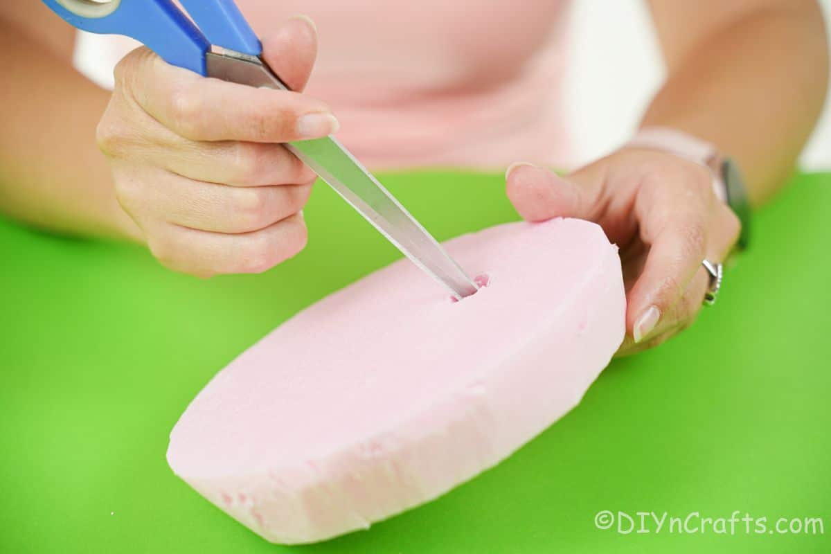 cutting hole into pink styrofoam