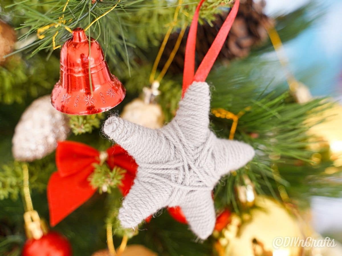 star ornament hanging on Christmas tree