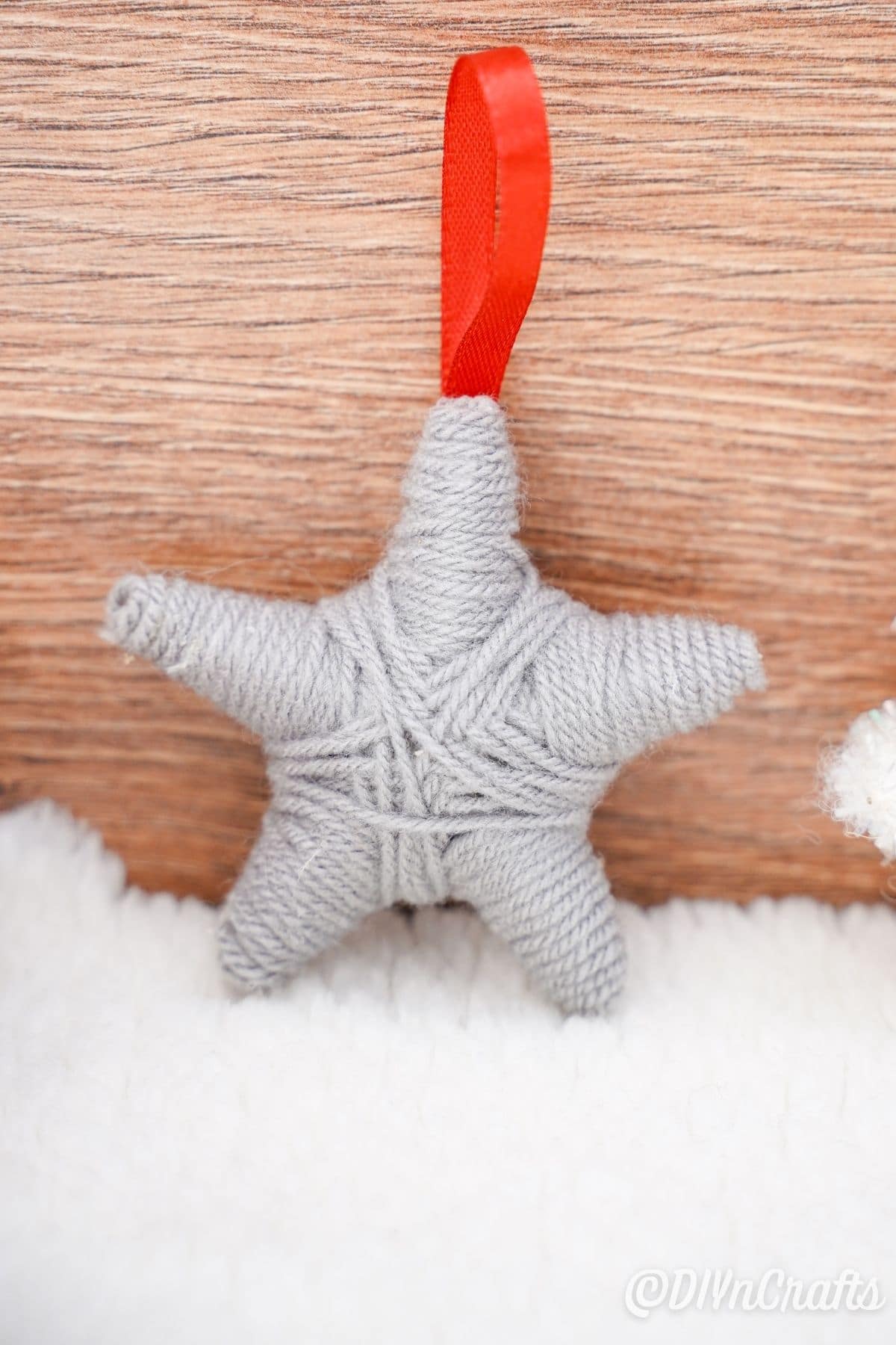 yarn star ornament against wood