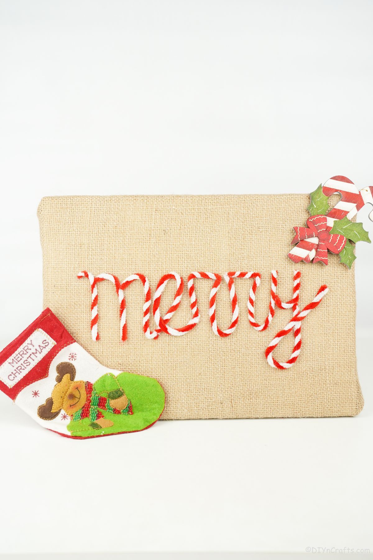 Christmas sign made of burlap on white wall