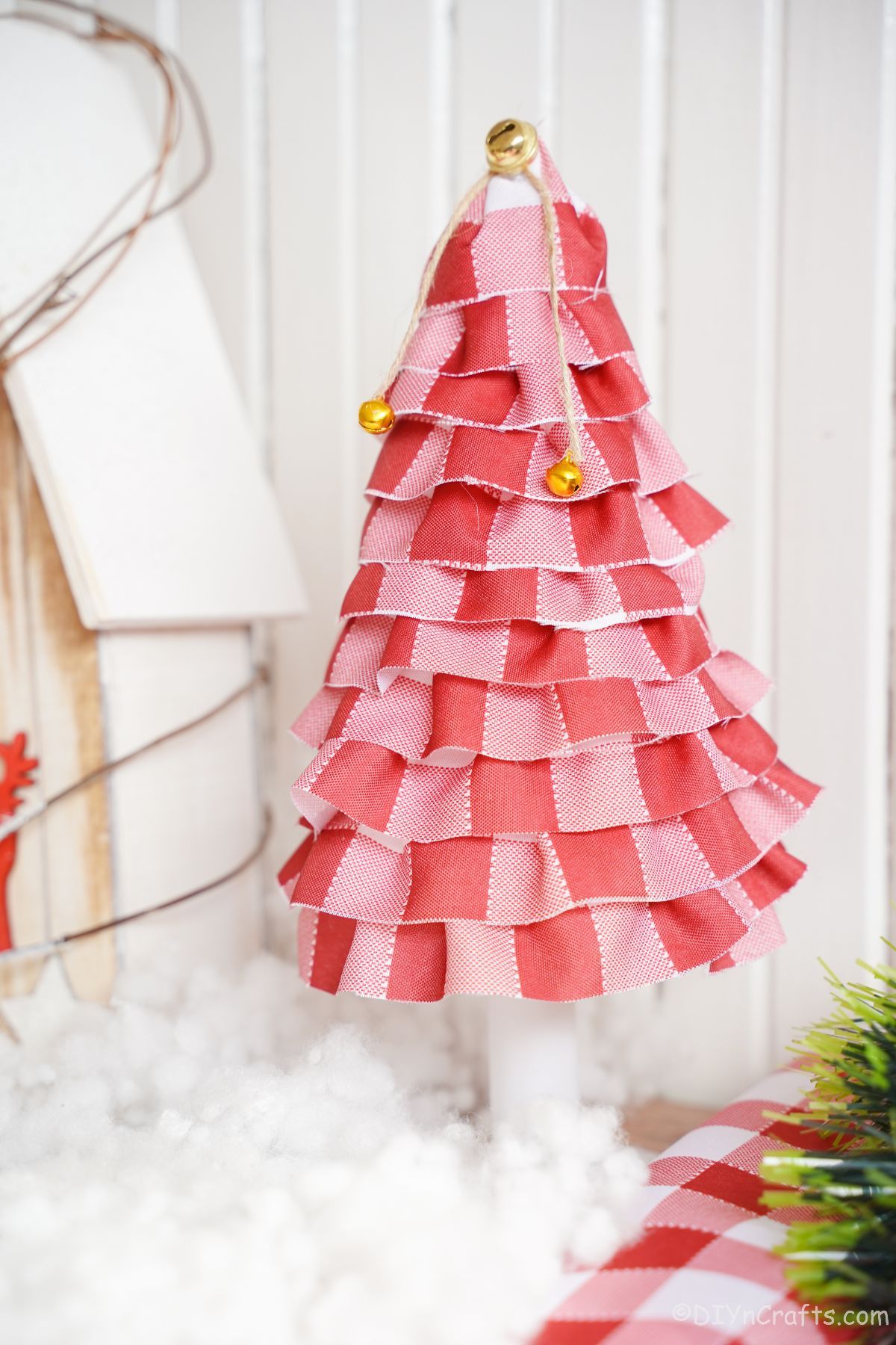 mini fabric tree in front of white shiplap