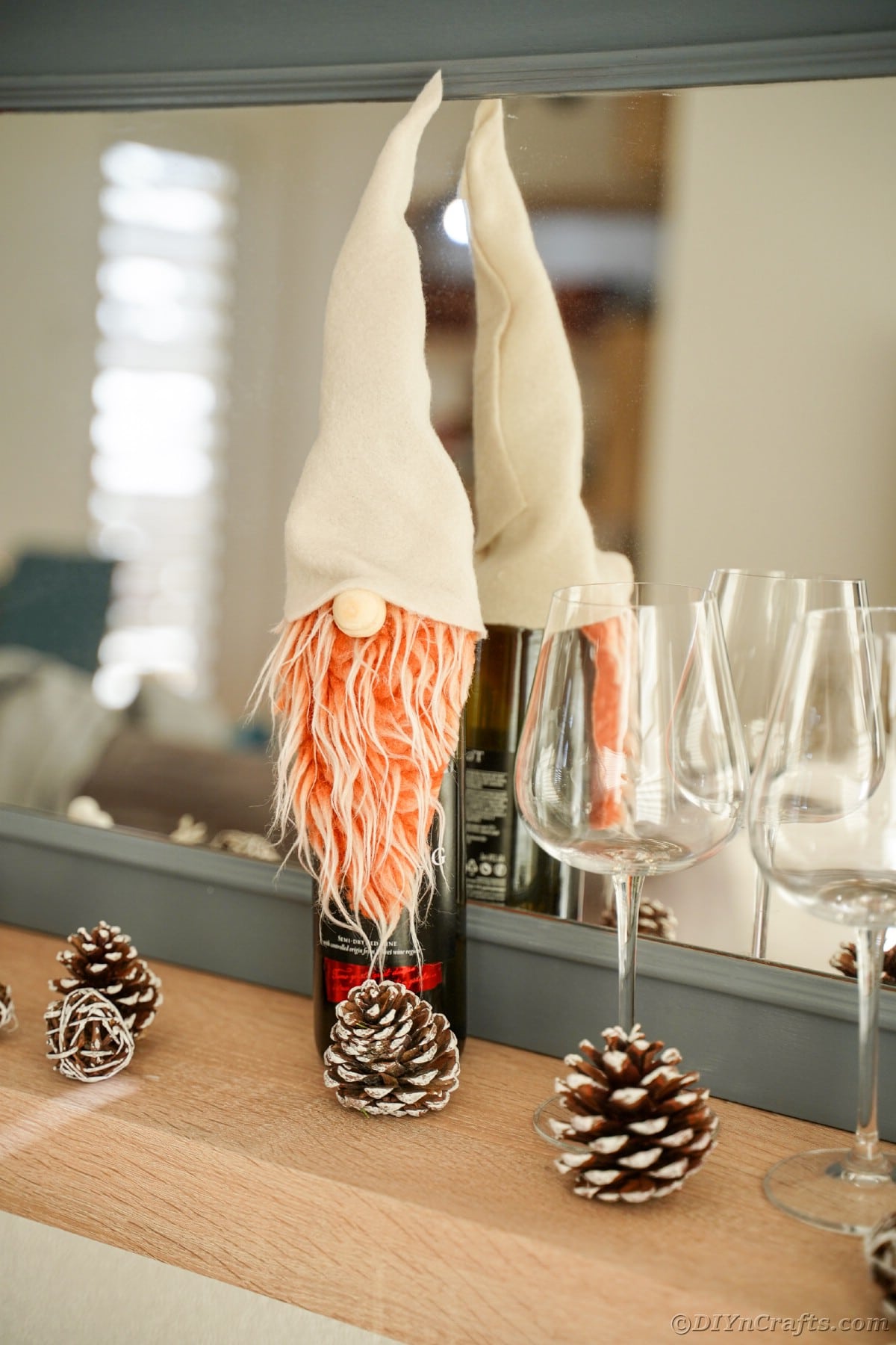 wine bottle gnome cover in front of gray mirror