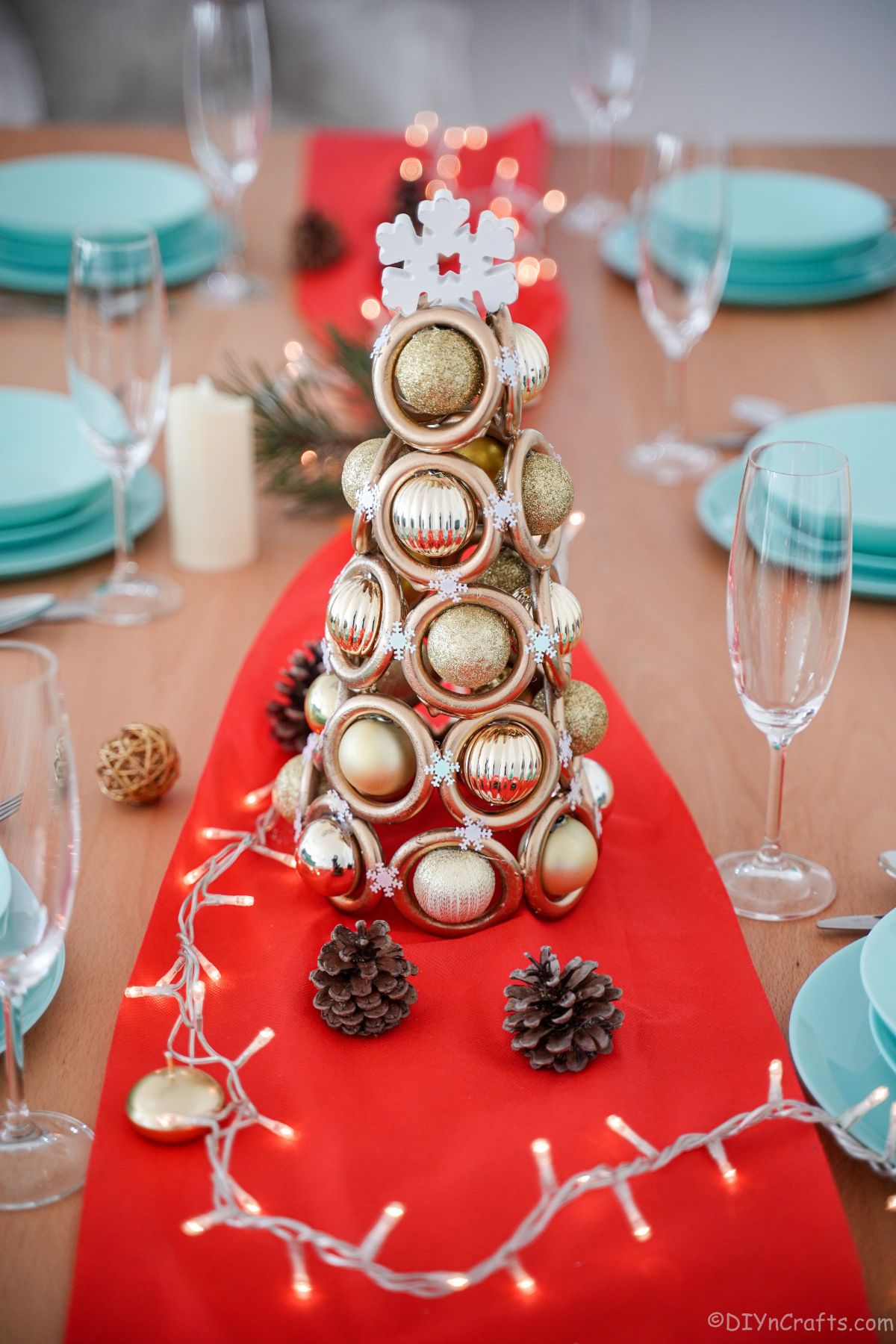 Miniature gold tree on red table runner