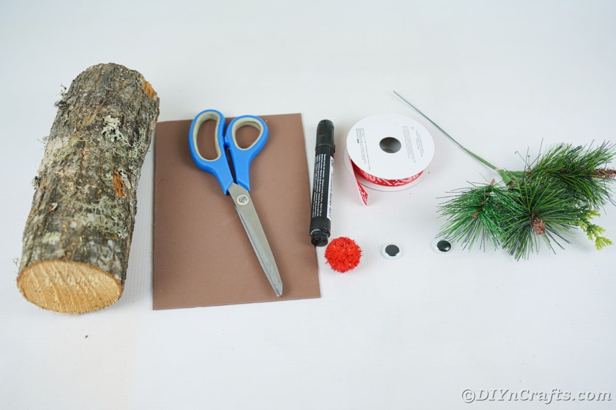 wood brown paper scissors and other supplies on white table
