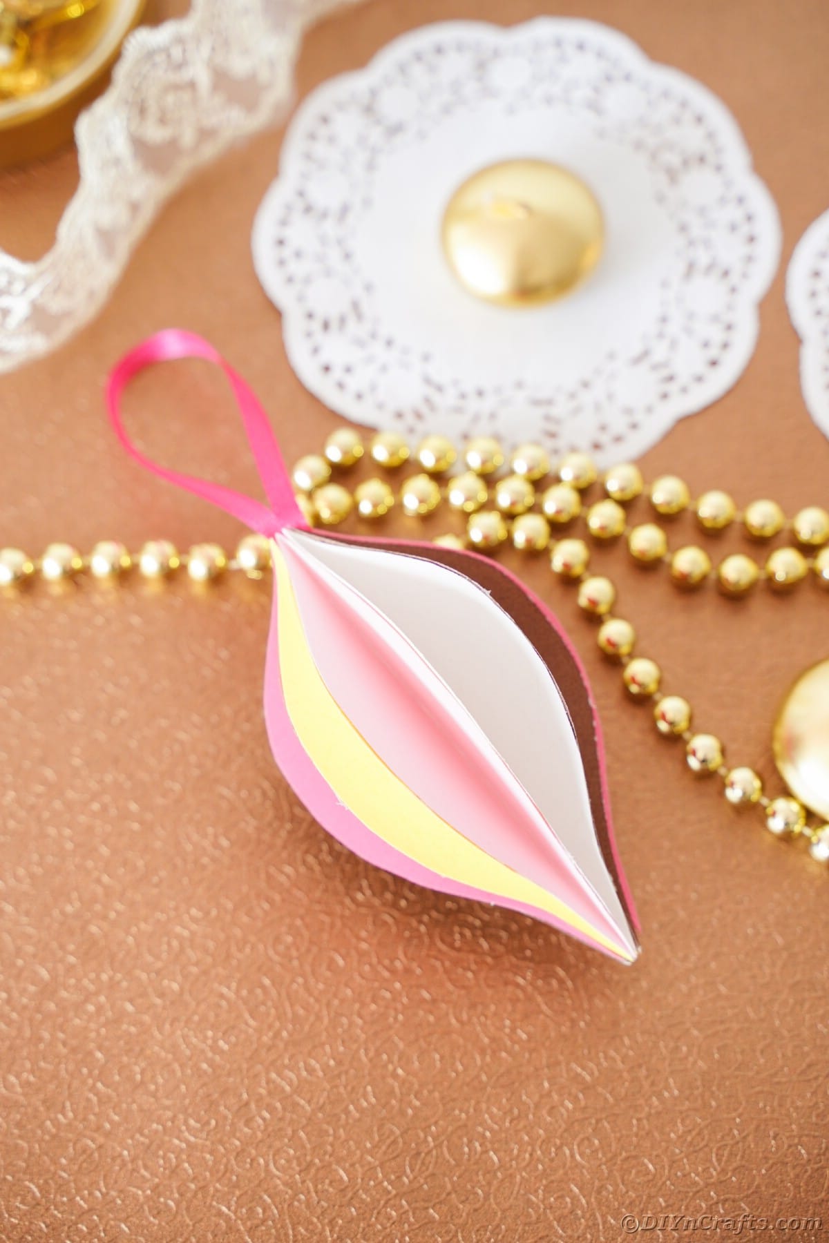 pink and yellow paper ornament on brown table
