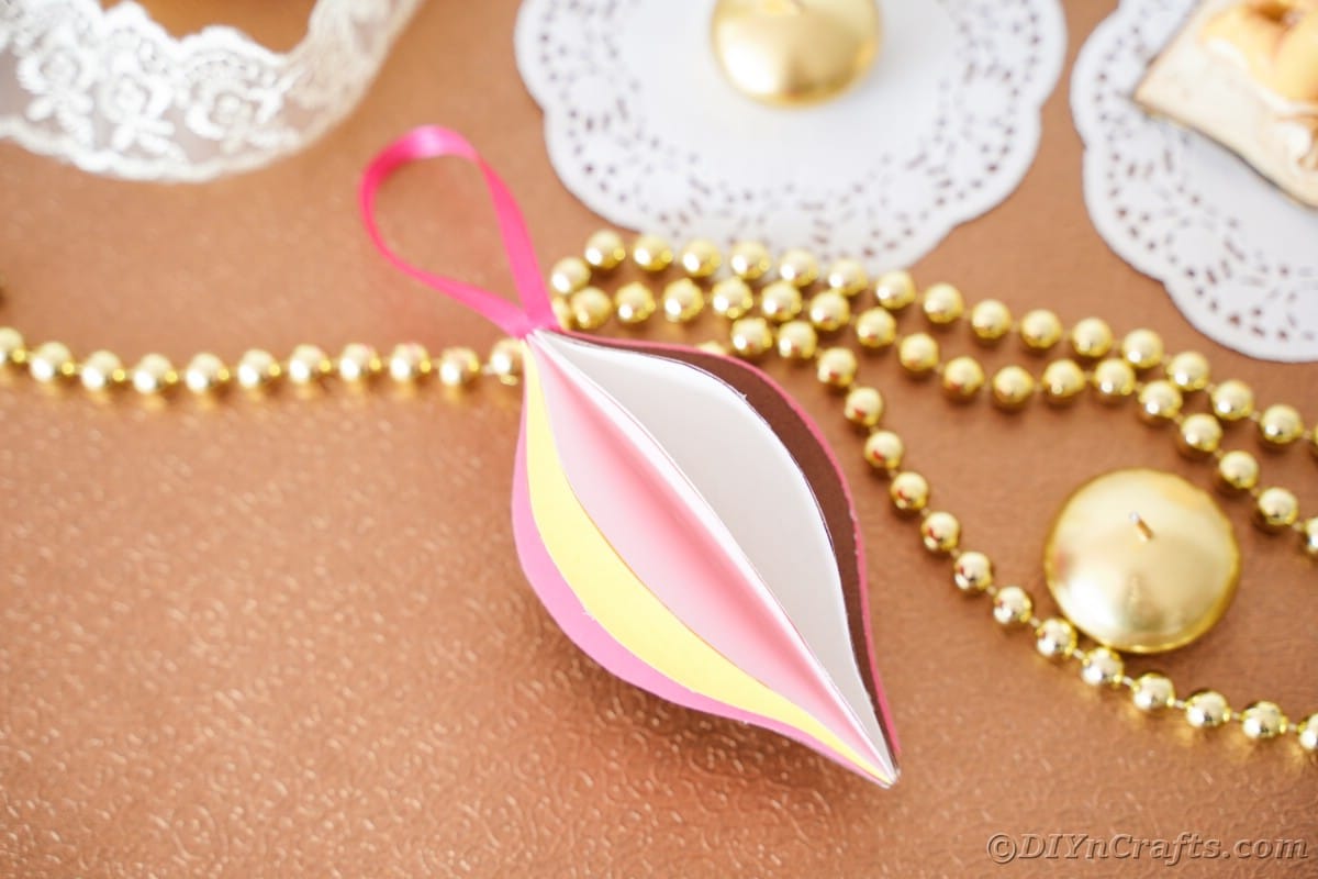 colorful paper teardrop ornament on wood tbale