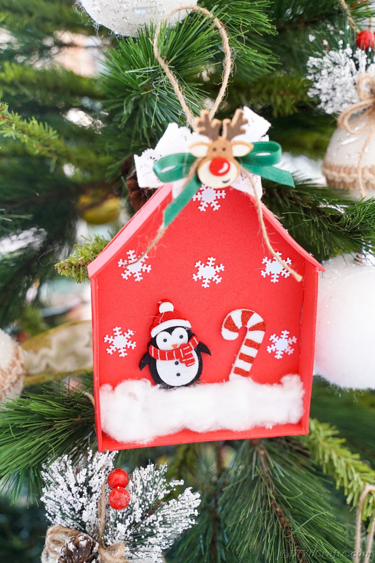 christmas tree with red foam ornament shaped like a house