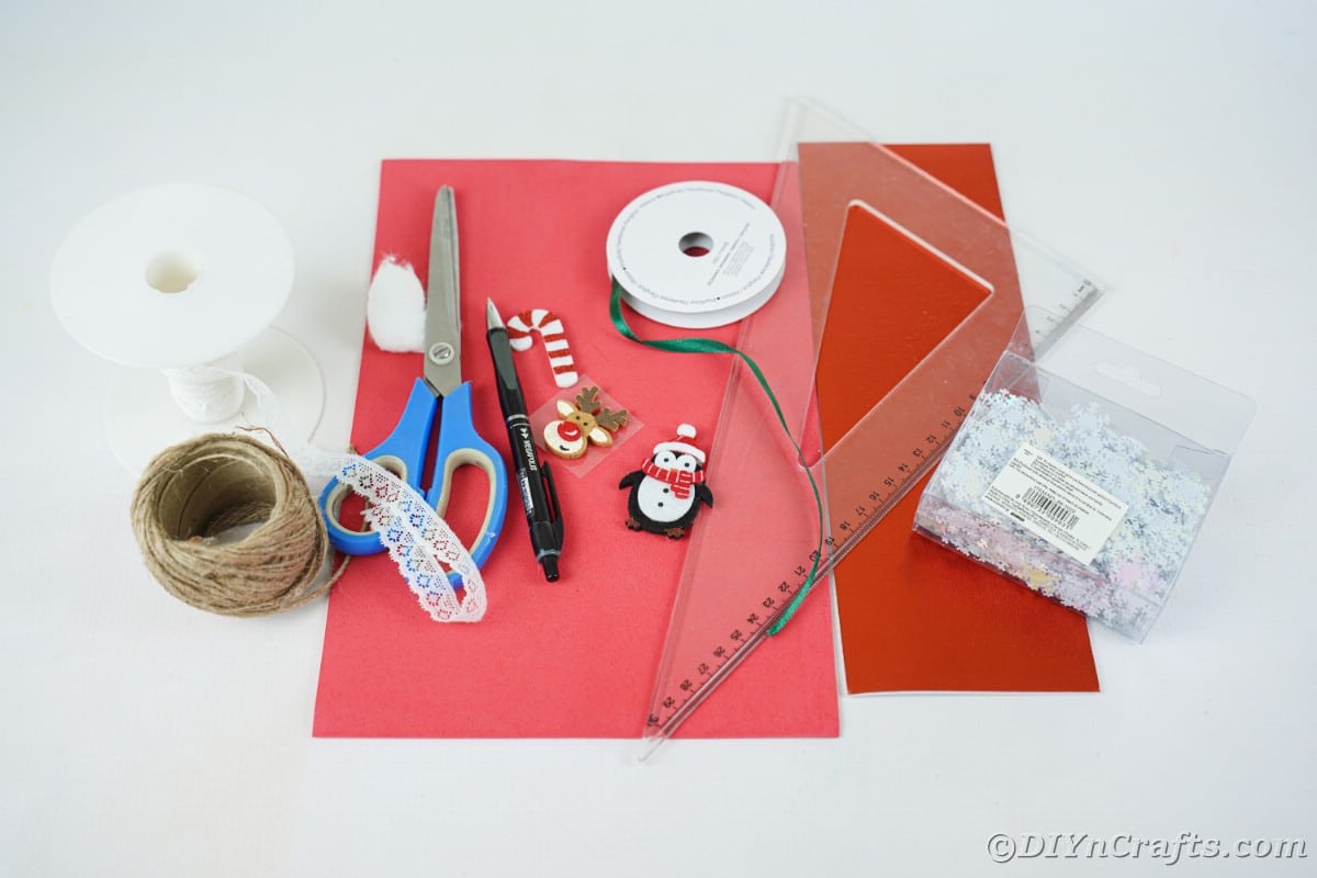 craft supplies such as scissors paper and ruler on white table