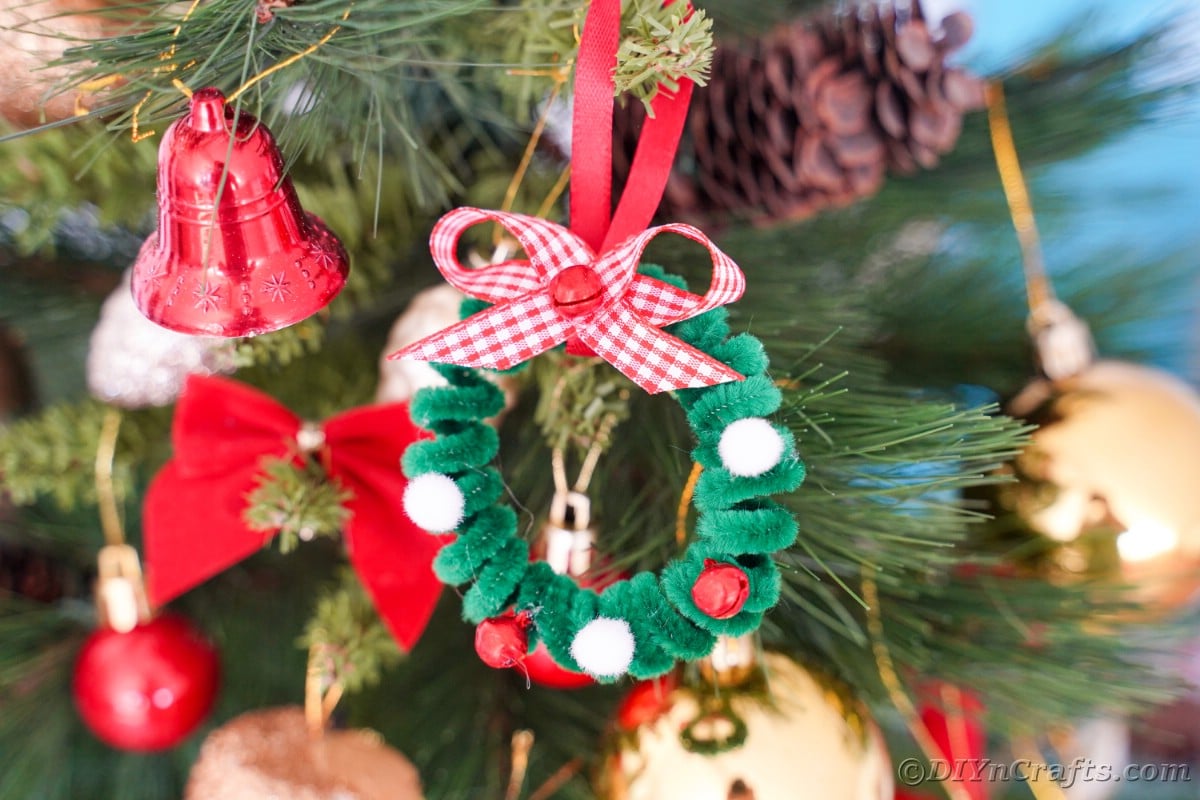 pipe cleaner ornament hanging on Christmas tree