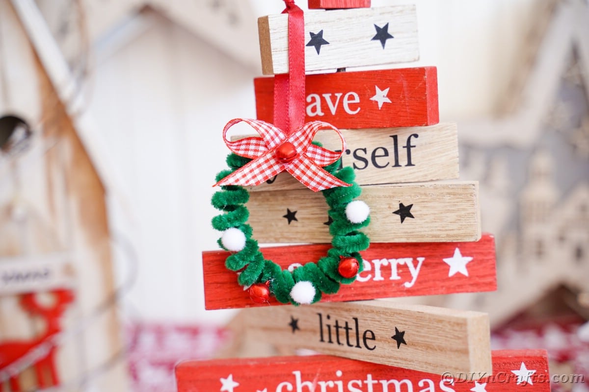 mini wreath ornament hanging on wood Christmas decoration