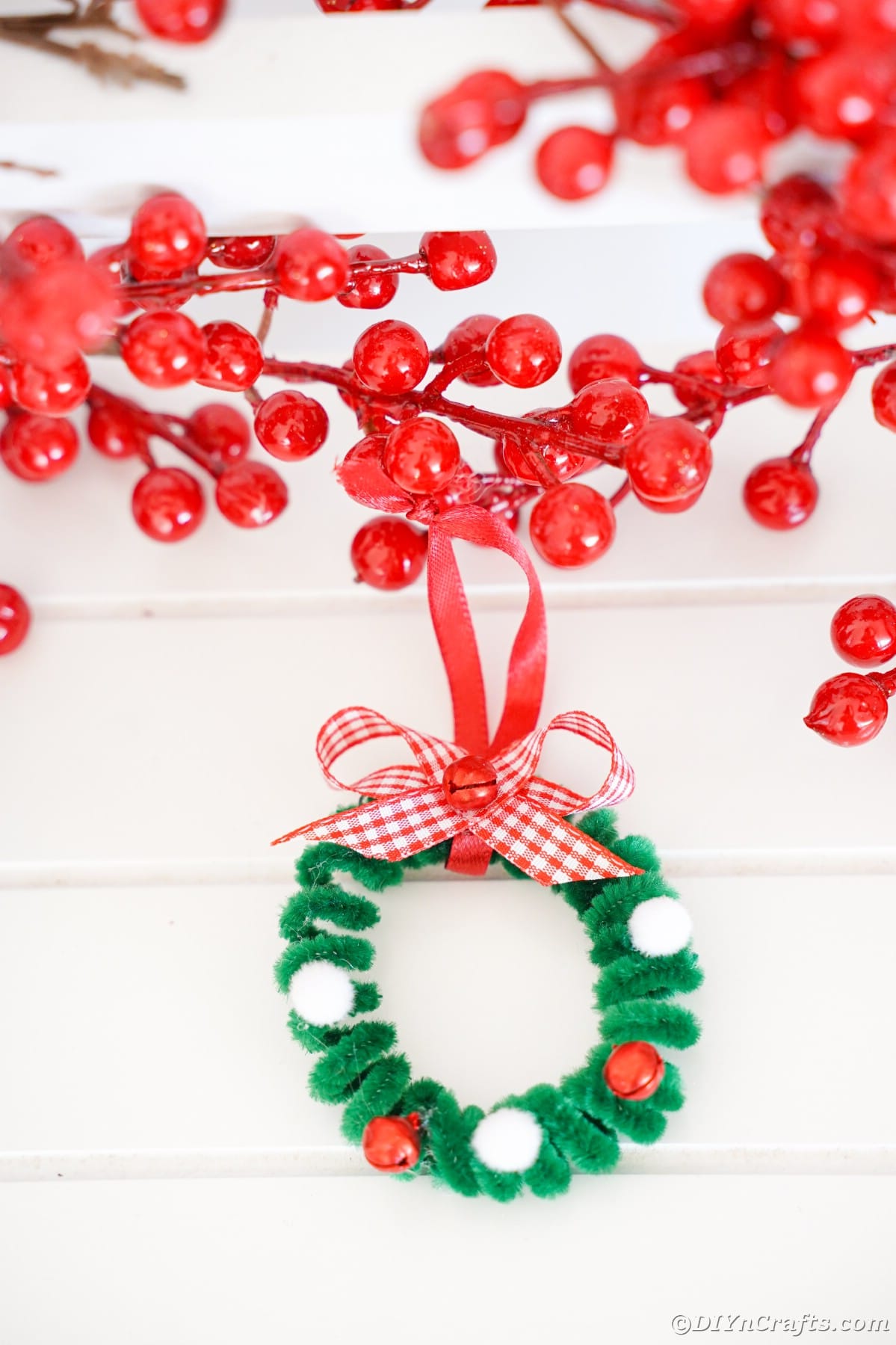 green wreath mini ornament hanging on berries