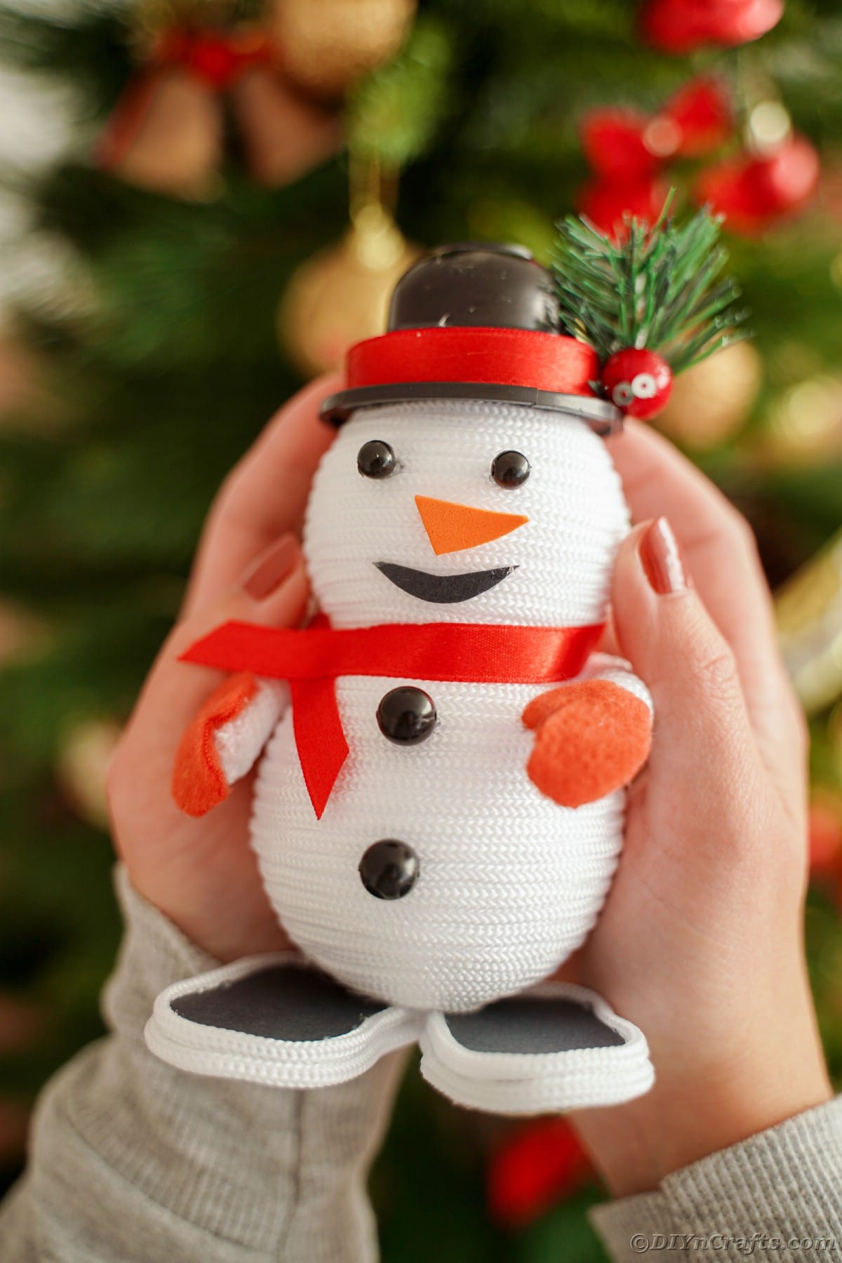 mini snowman decoration held in hands