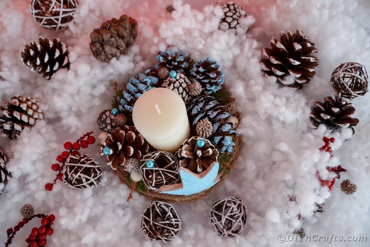 blue star and pinecone centerpiece with candle on fake snow