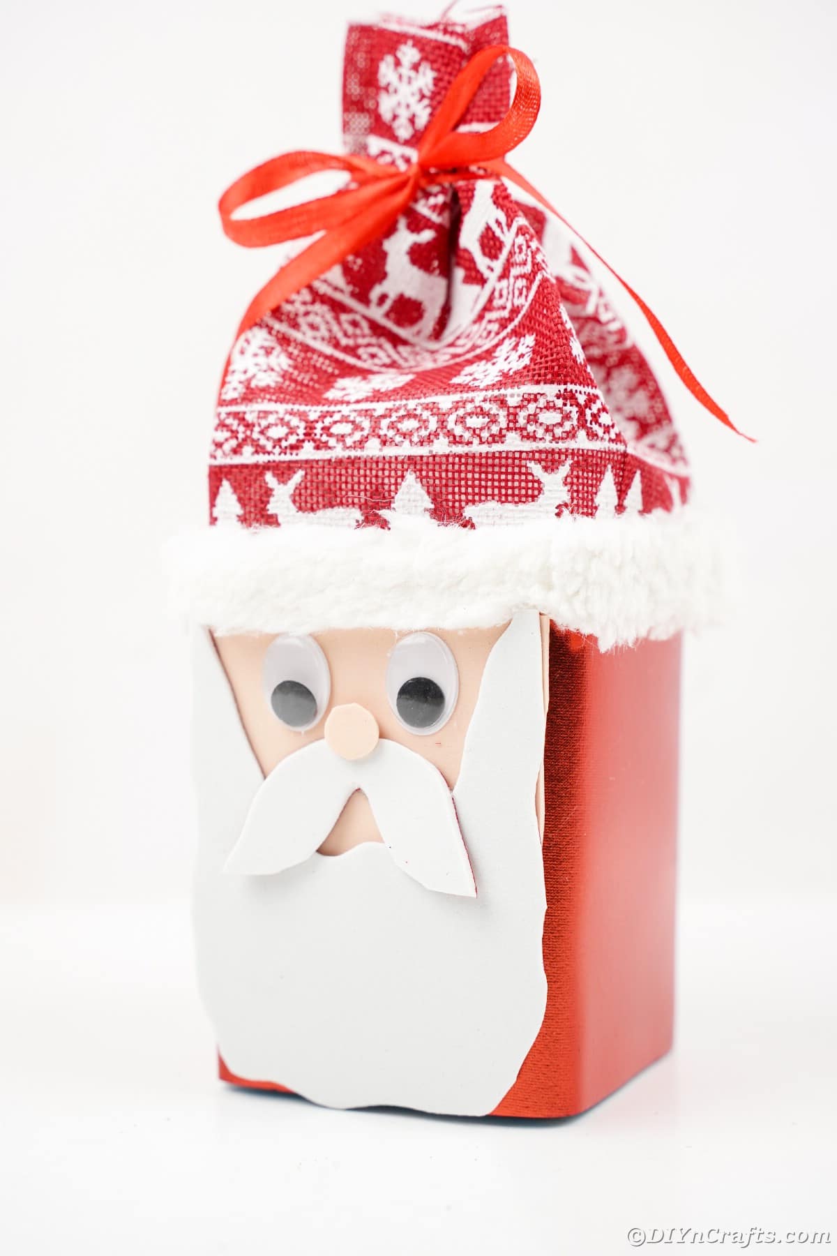 standing Santa Claus box with nordic hat on white table