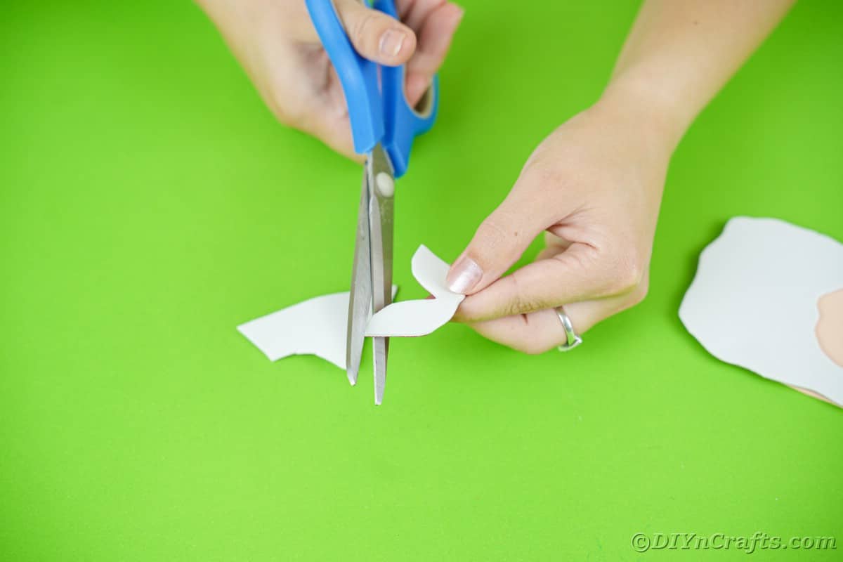 scissors cutting white mustache from paper