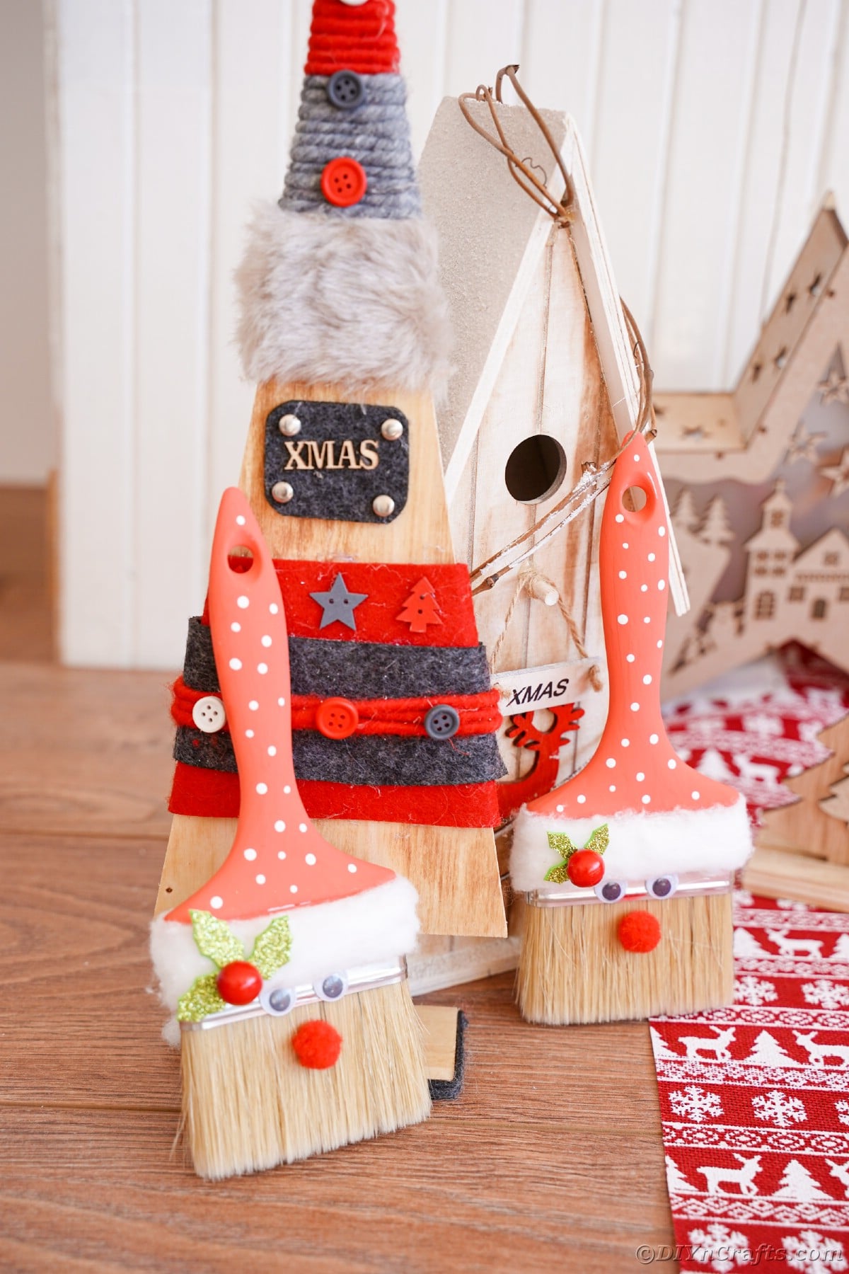 wooden tree on table with paintbrush santa in front