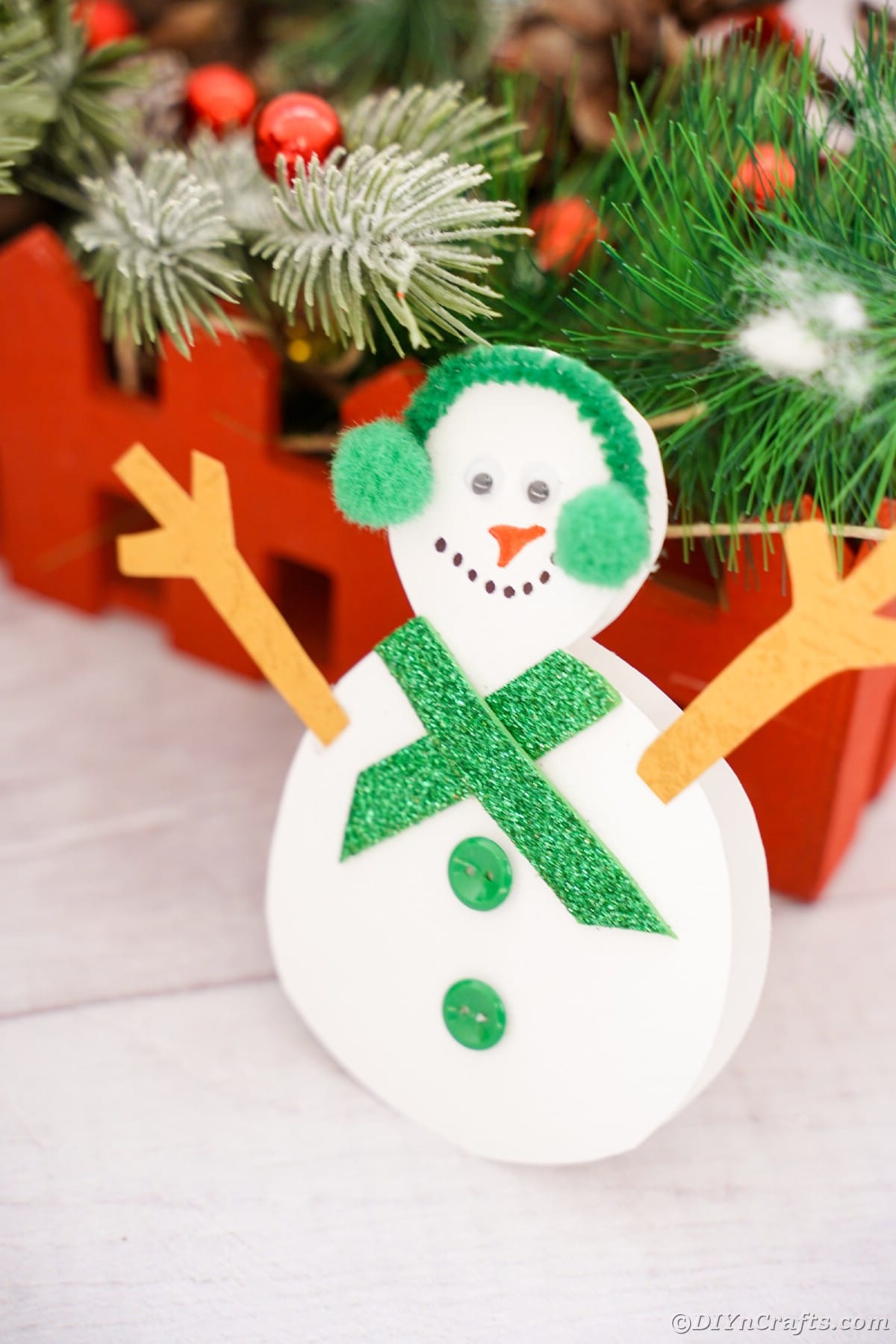 snowman decoration by red crate