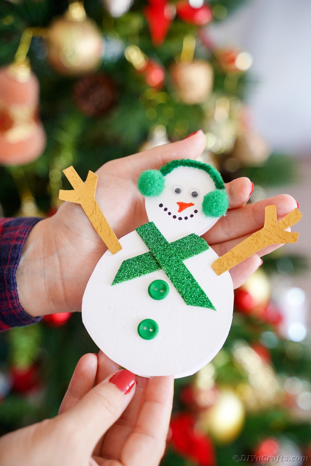 paper snowman in hands