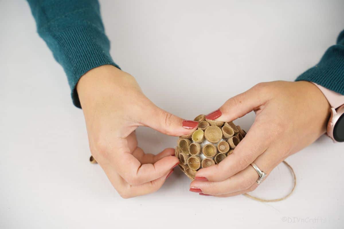 gluing acorn caps onto ornament
