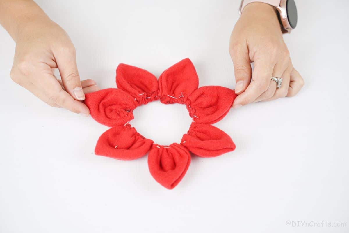 red fabric flower on white table