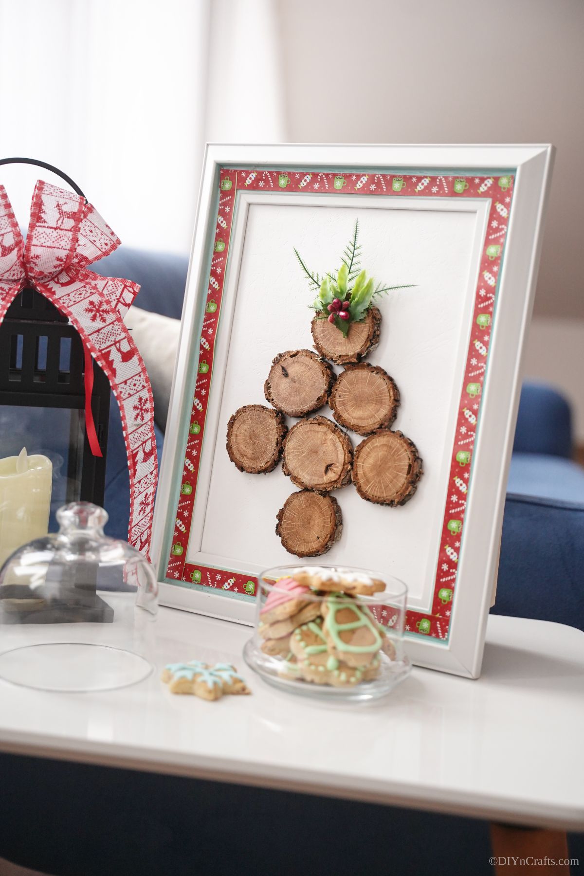 white and red frame on table with wood slice tree next to glass jars