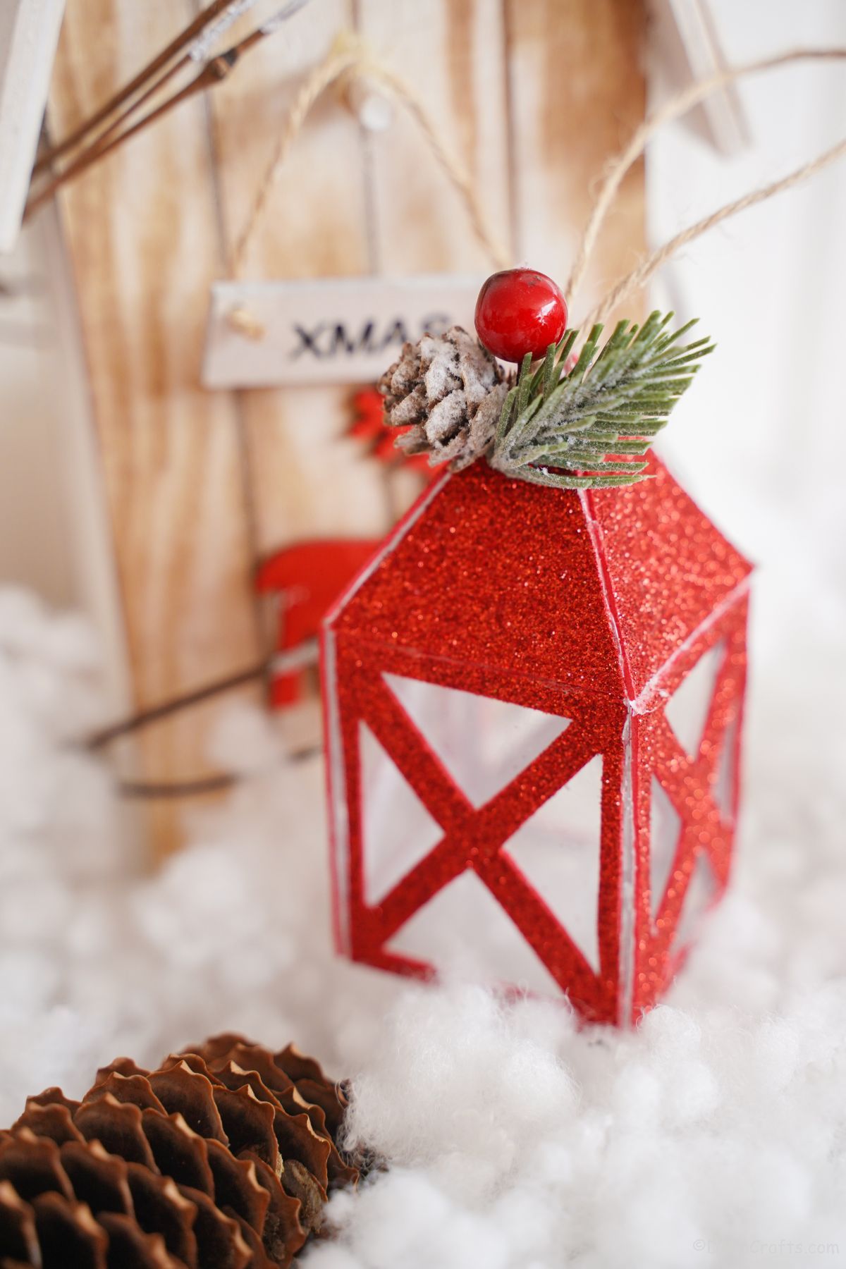 wooden bird house in fake snow by mini red lantern