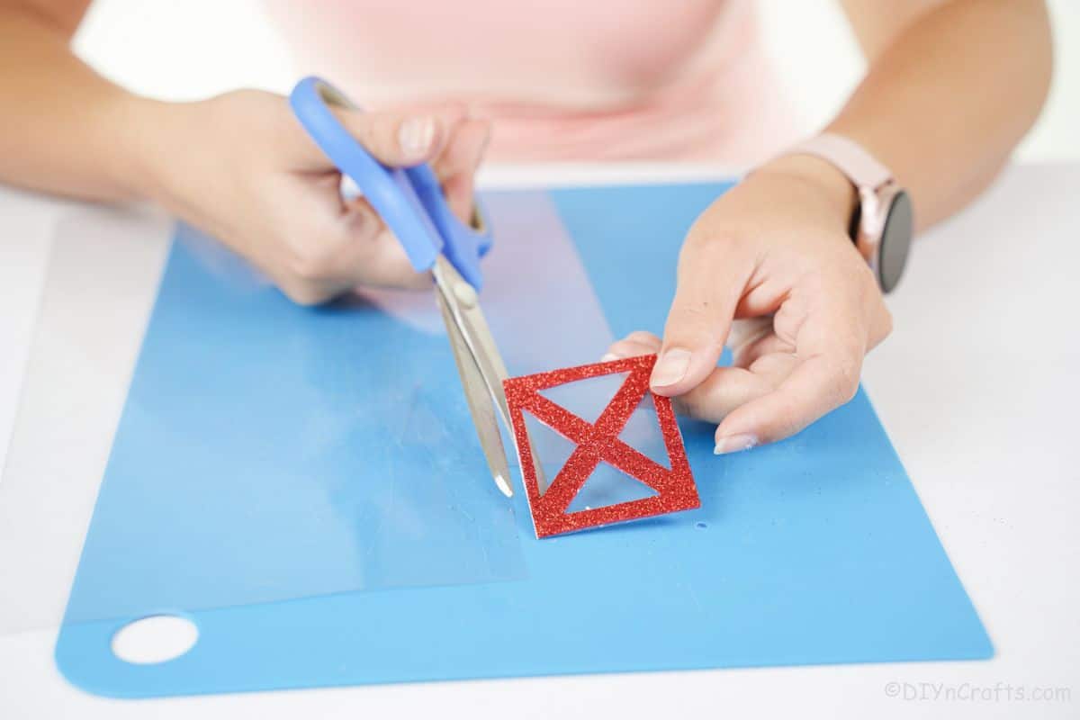 hand cutting lantern wall out of plastic sheet