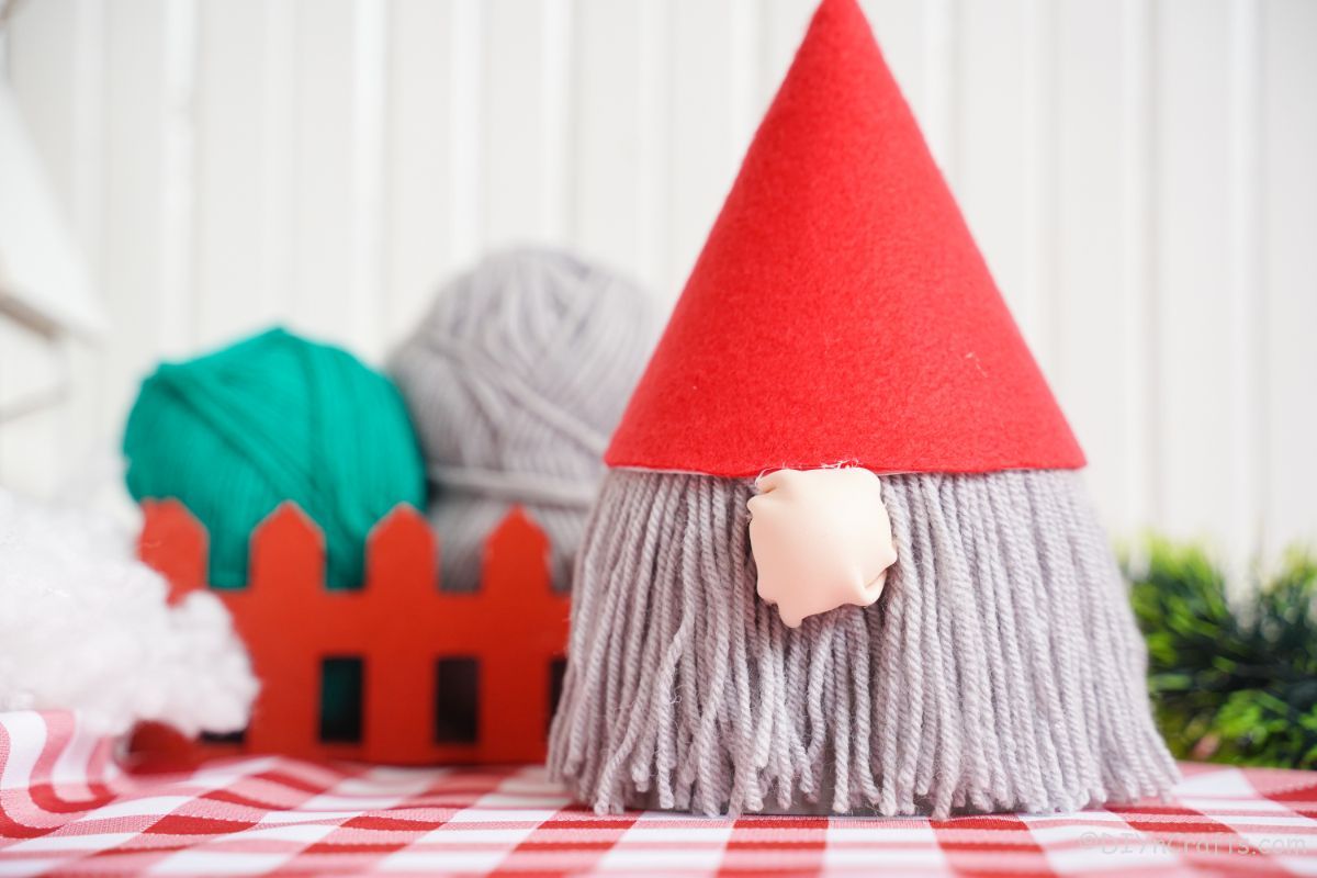 red and white checked tablecloth underneath gnome with red hat