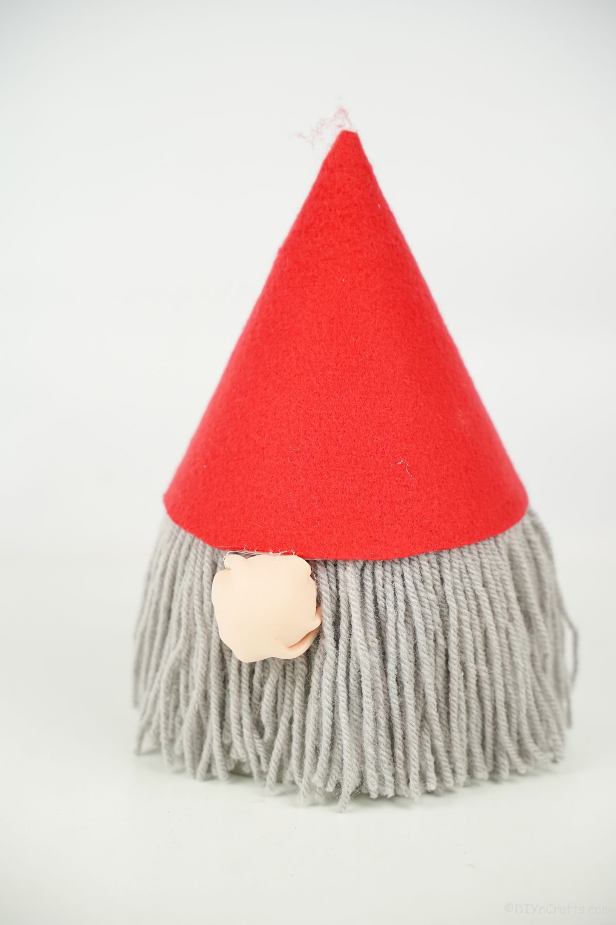 red hat gray beard on gnome on white surface