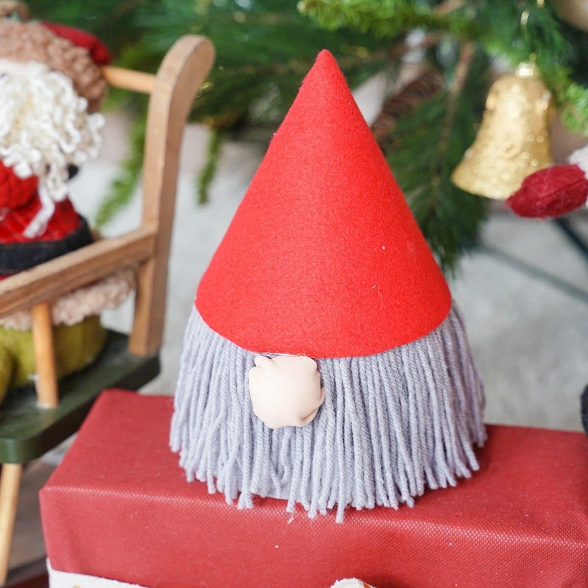 gnome with gray beard on top of red package