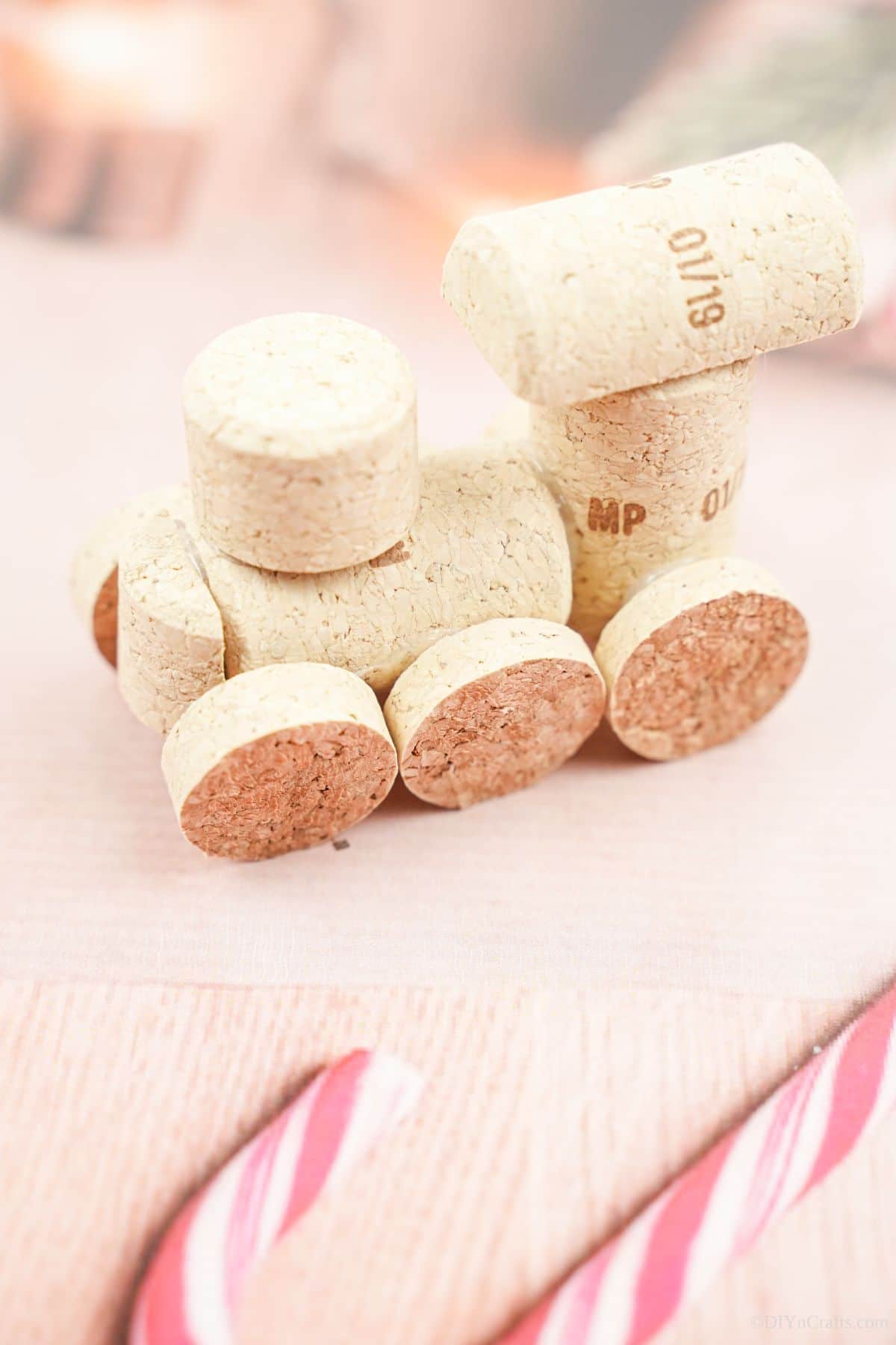 wine cork train ornament laying on holiday themed paper