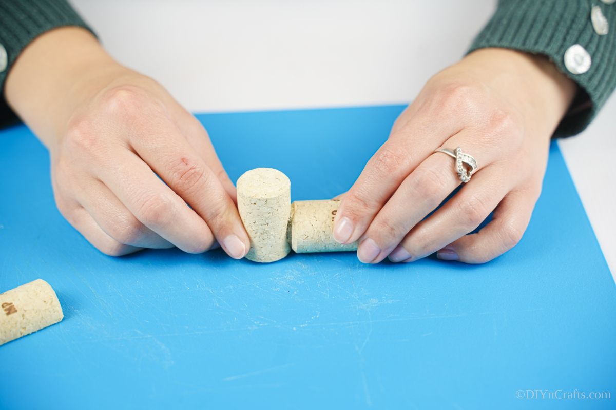 gluing two corks together on blue mat