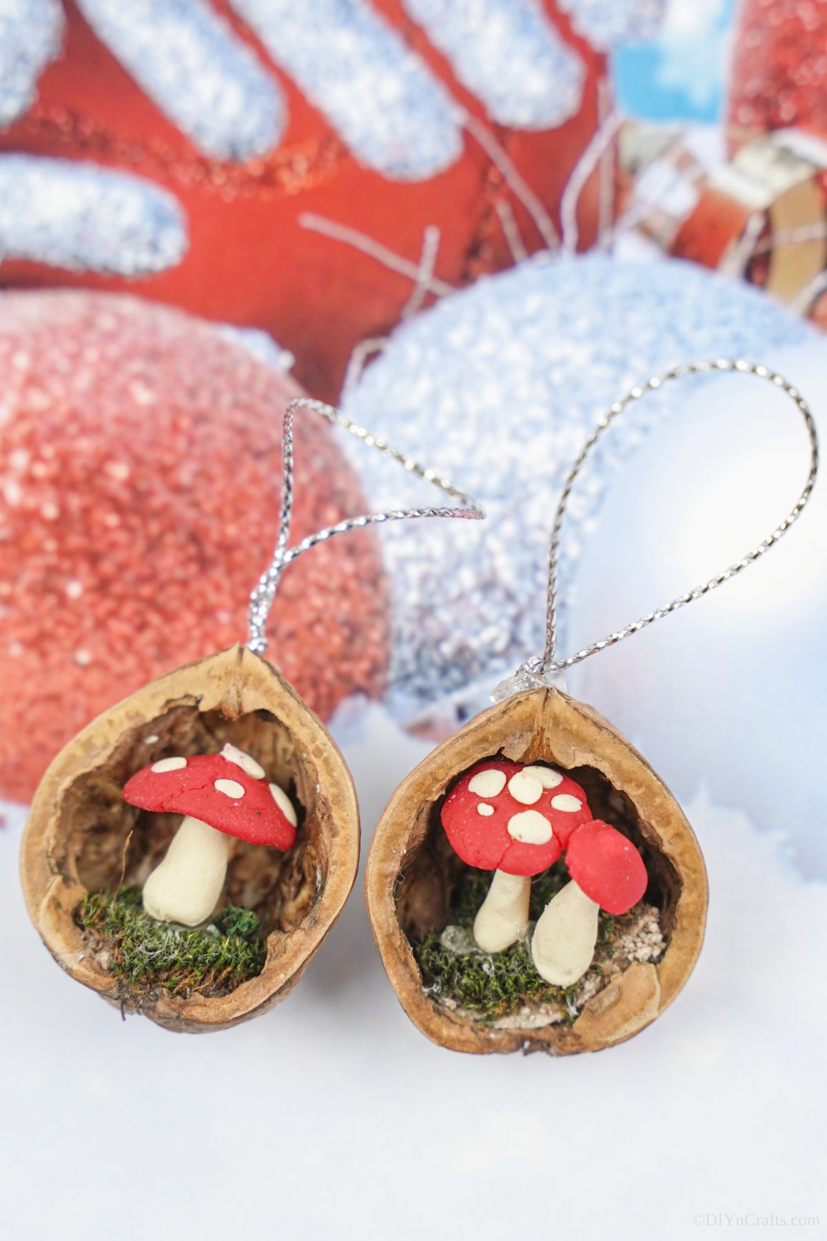Scandinavian style walnut shell mushroom ornaments on holiday themed paper