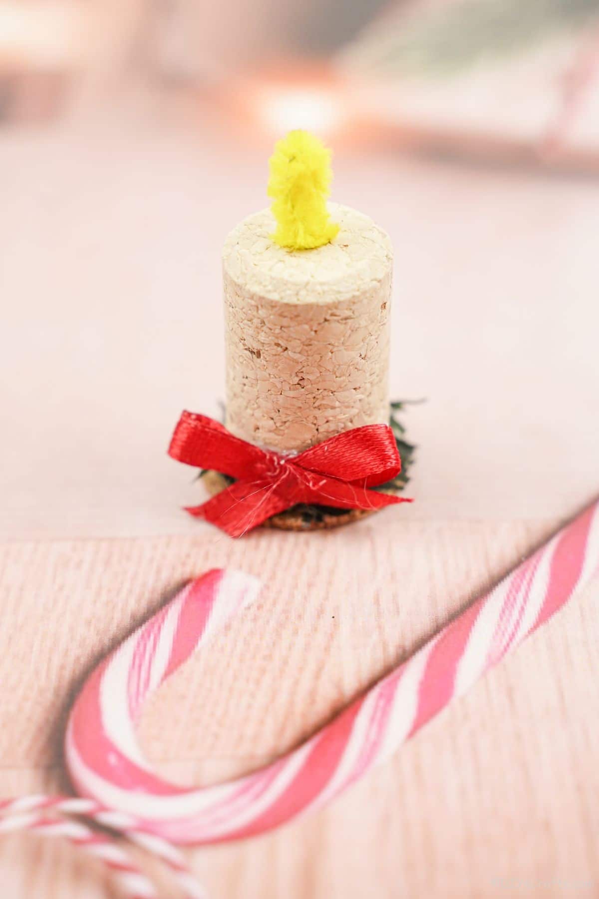 wien cork candle on holiady themed paper with candy cane
