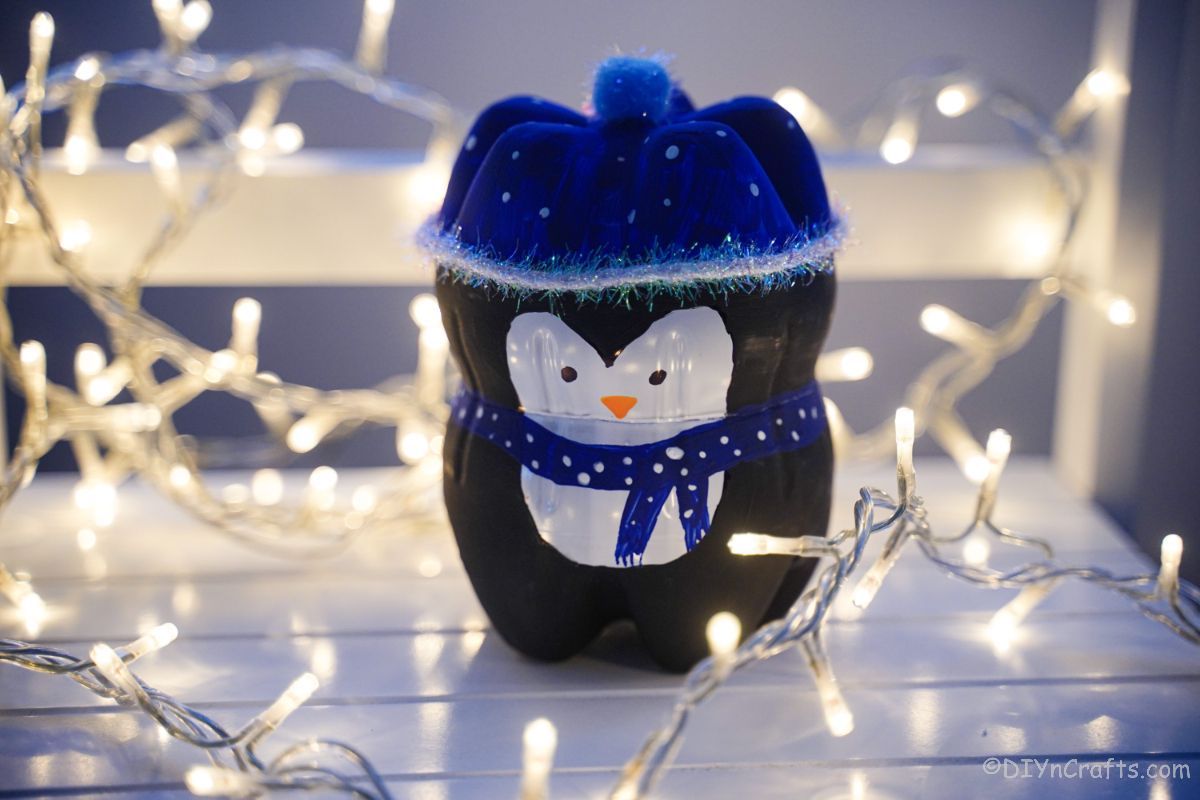 black and blue penguin decoration on white table with lights