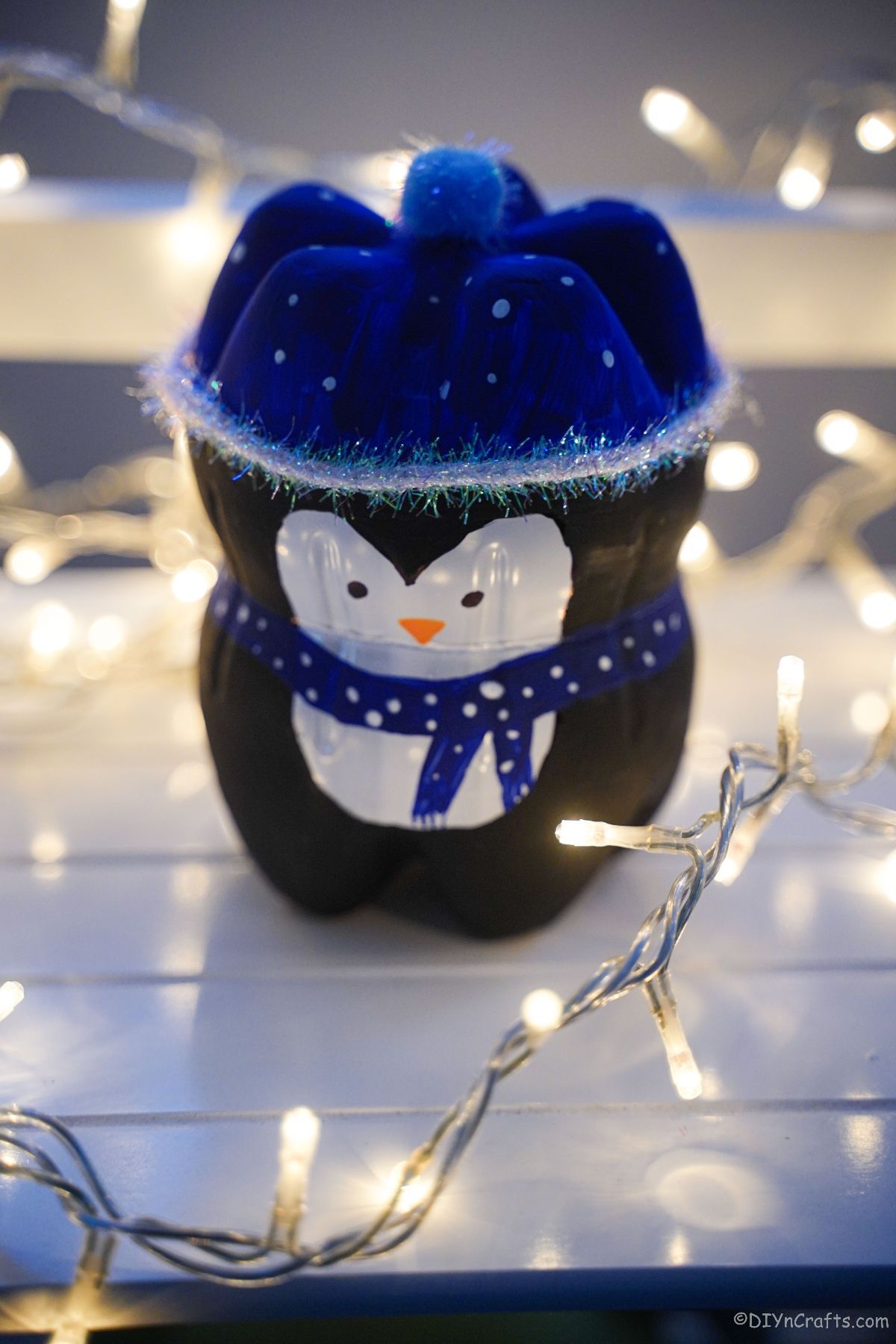fake penguin craft surrounded by twinkle lights