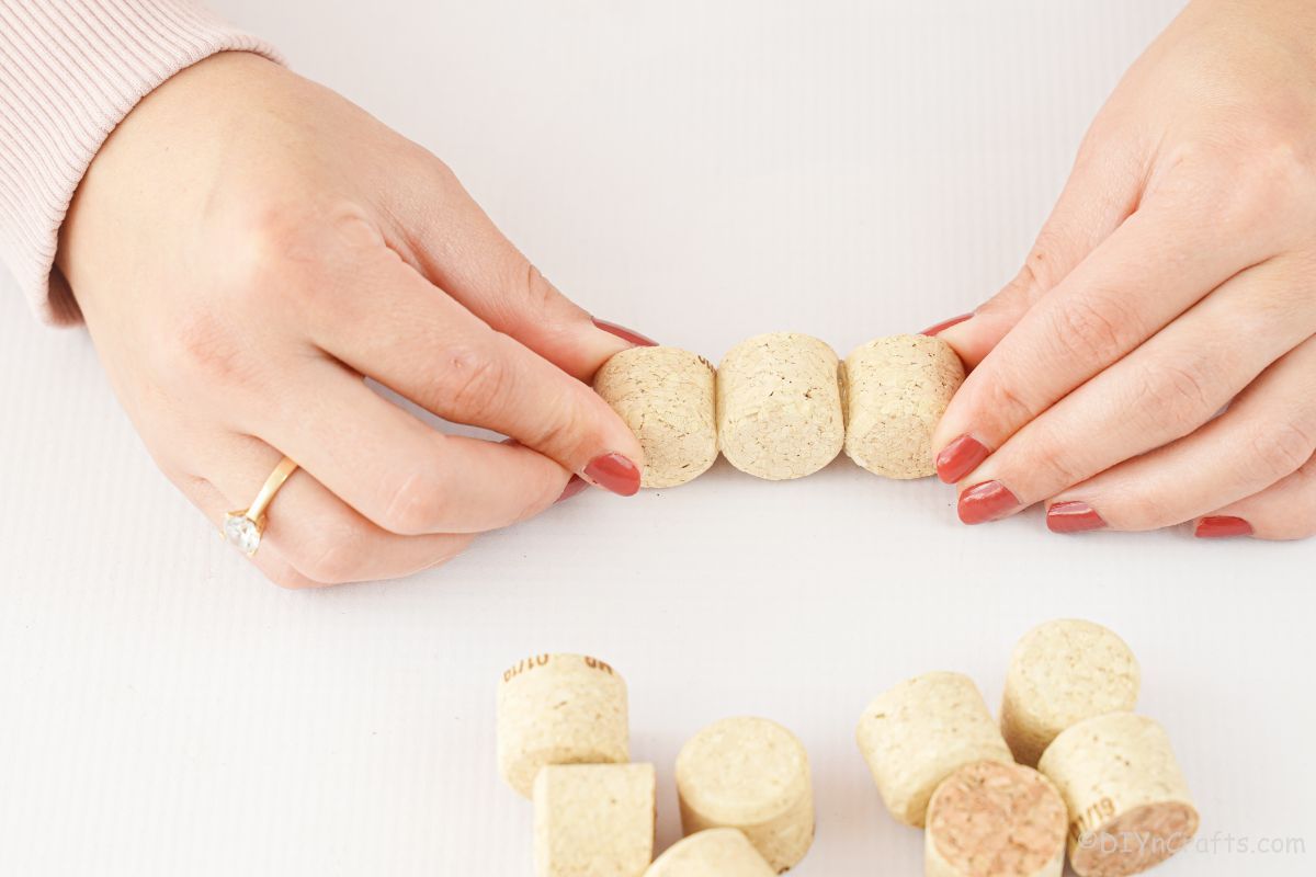 hands holding cork pieces together