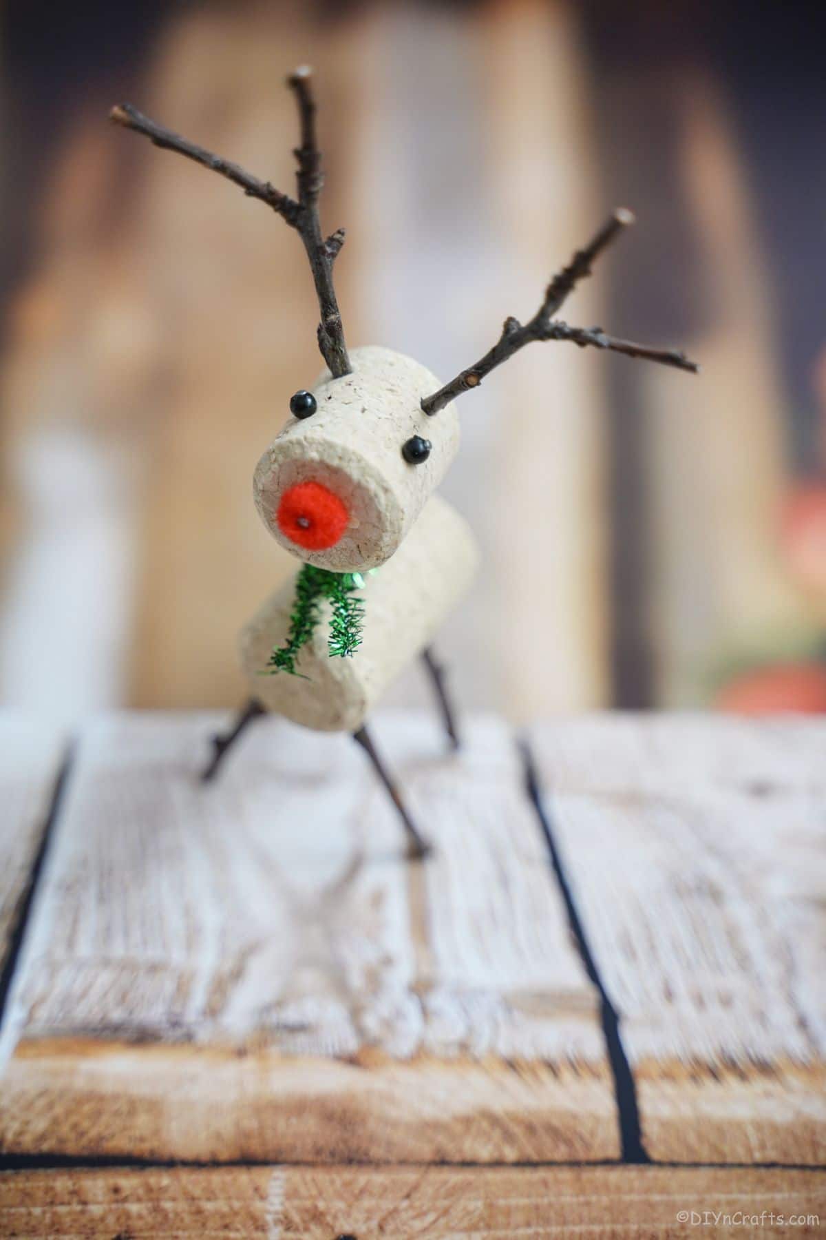 wine cork reindeer with twig antler on wood