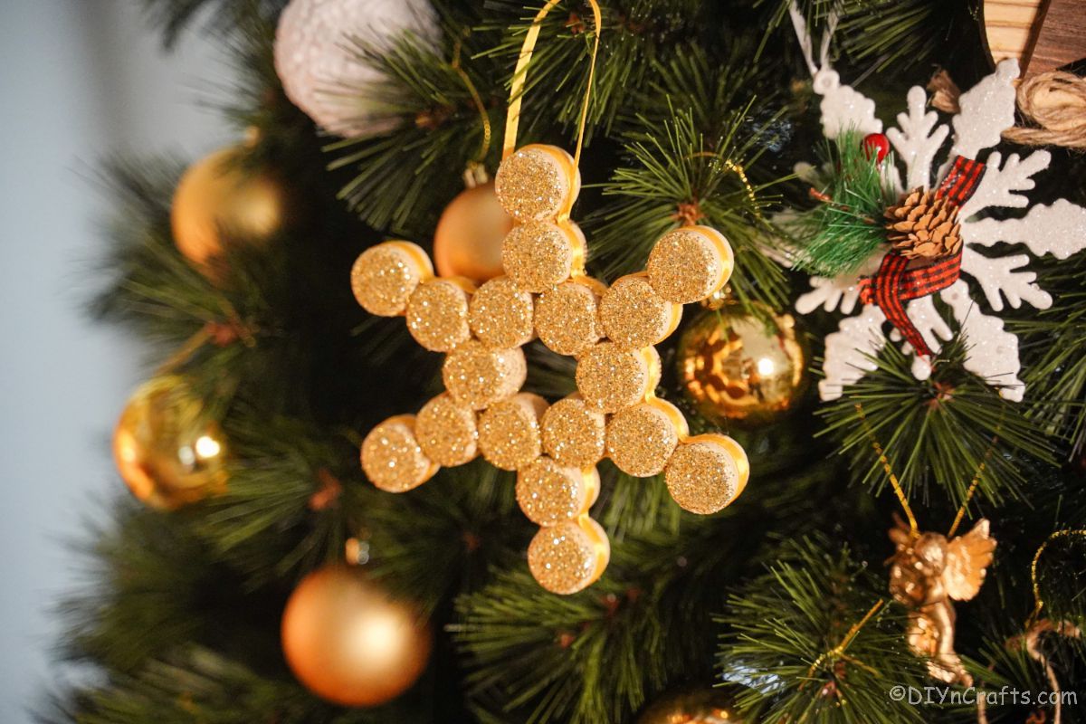 gold ornament hanging on holiday tree