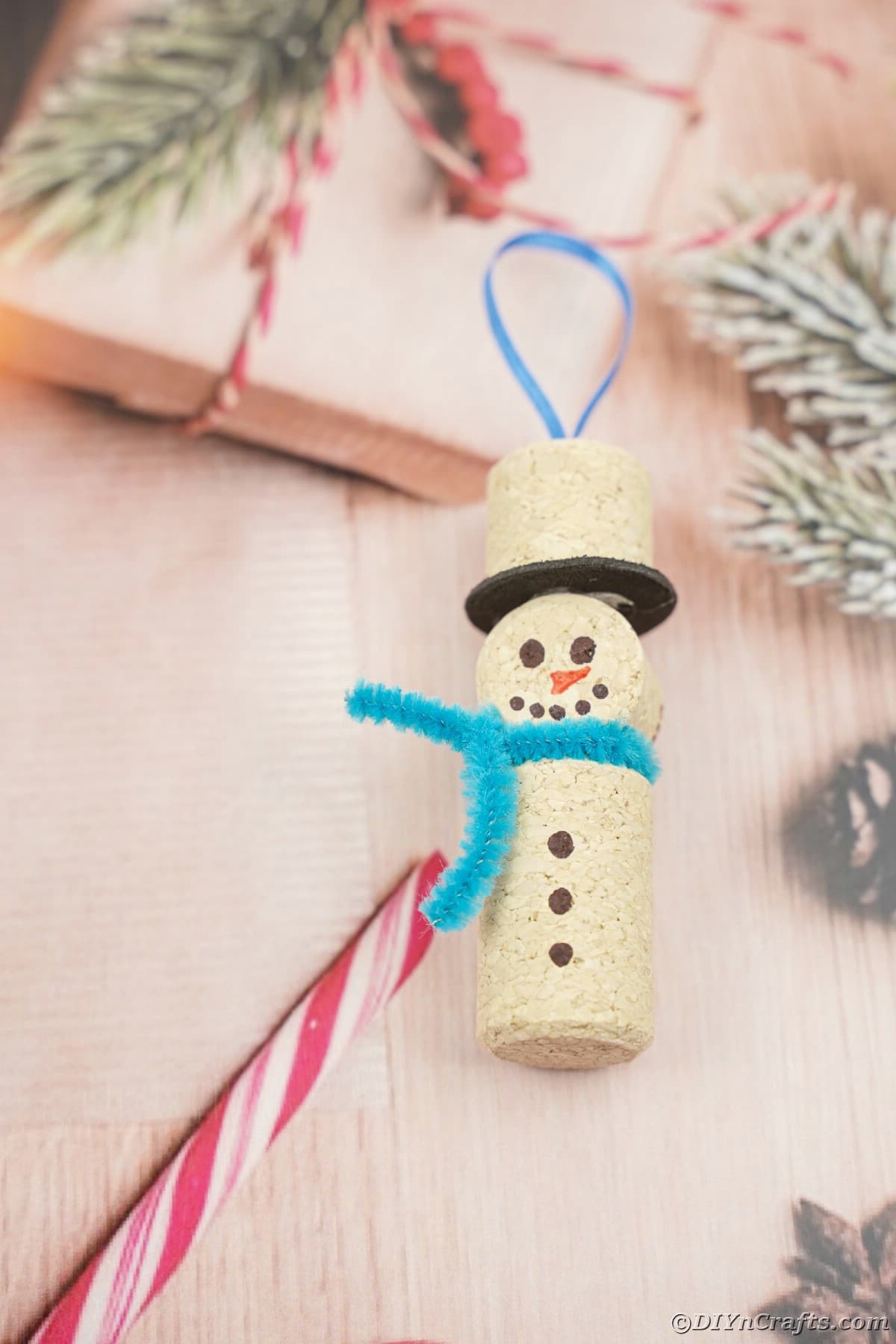 wine cork snowman ornament on holiday table paper