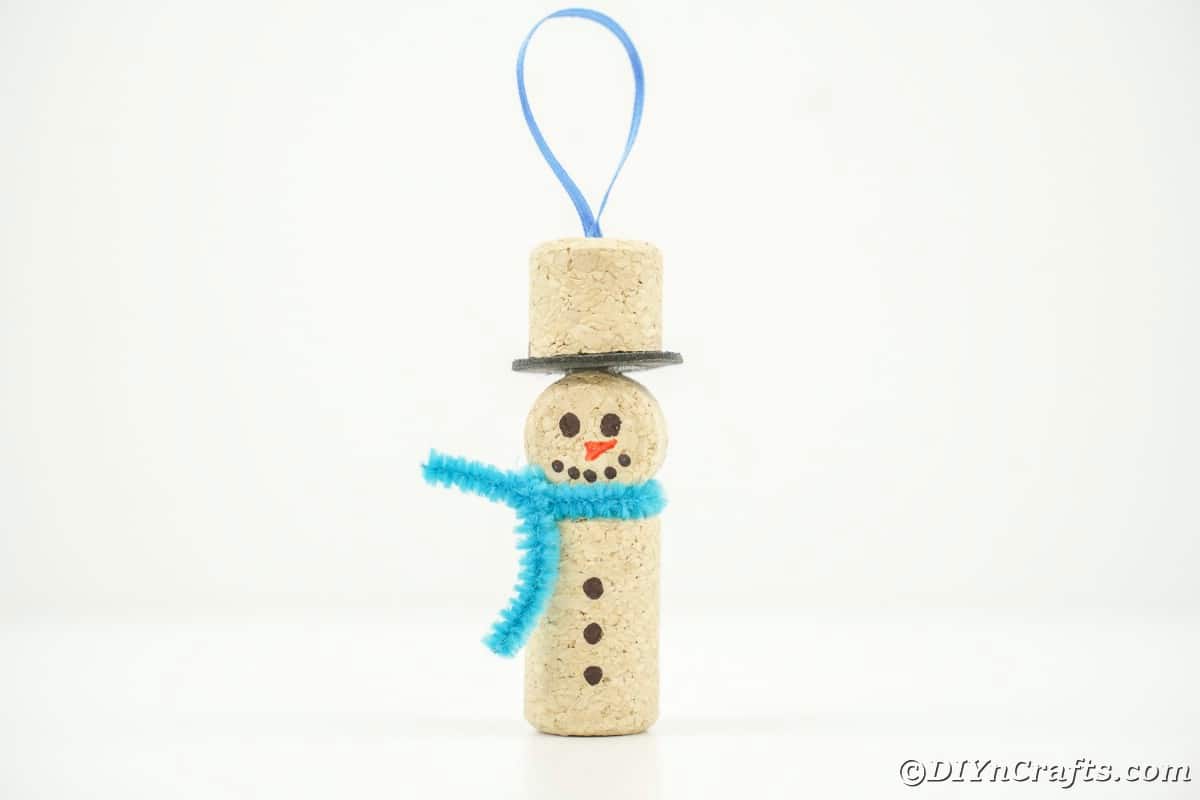 wine cork snowman with blue ribbon hanger on white table