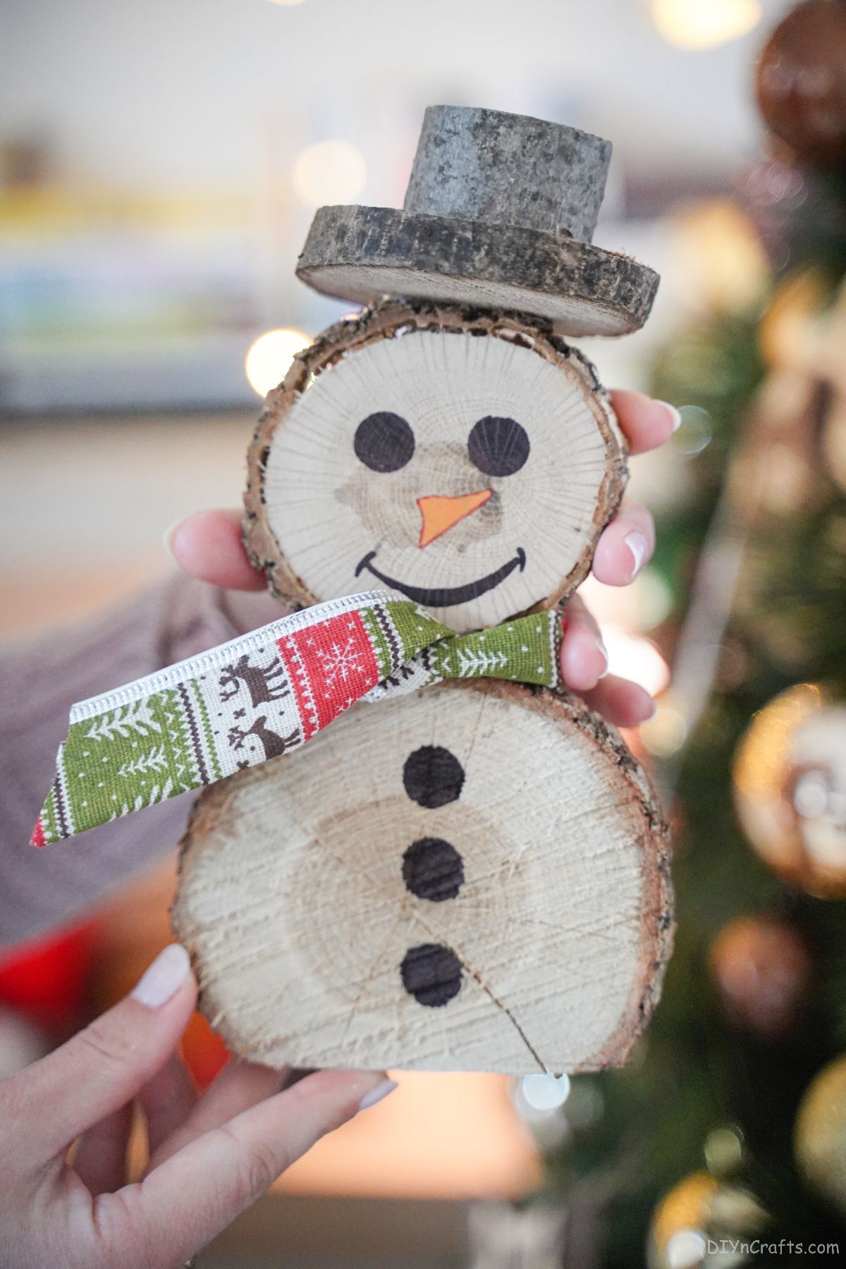 wood slice snowman with green and red ribbon scarf