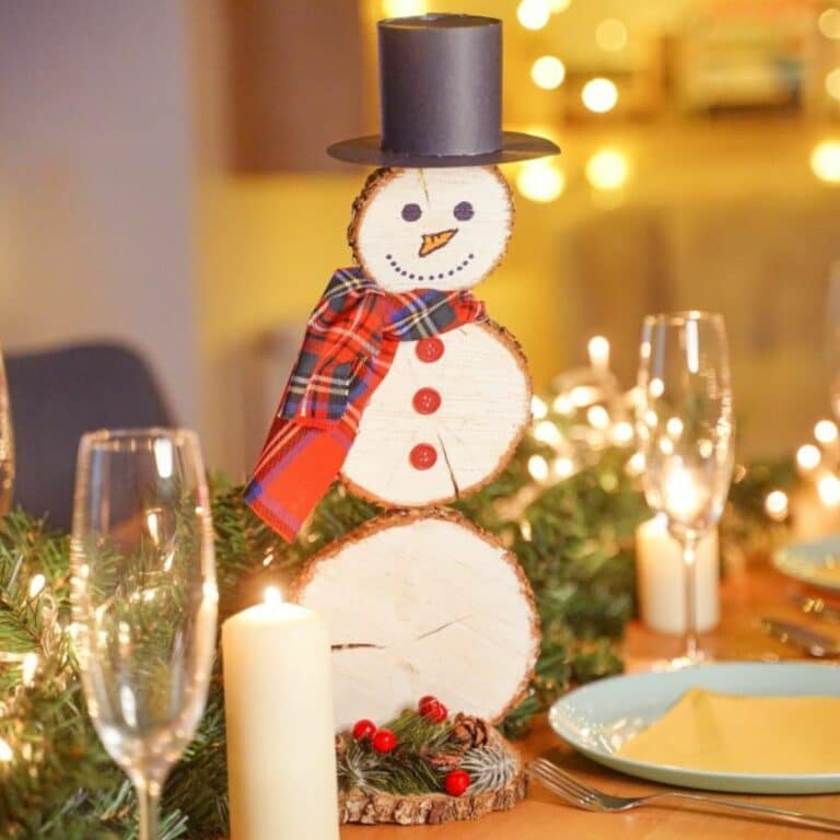 wood slice snowman on table with place settings